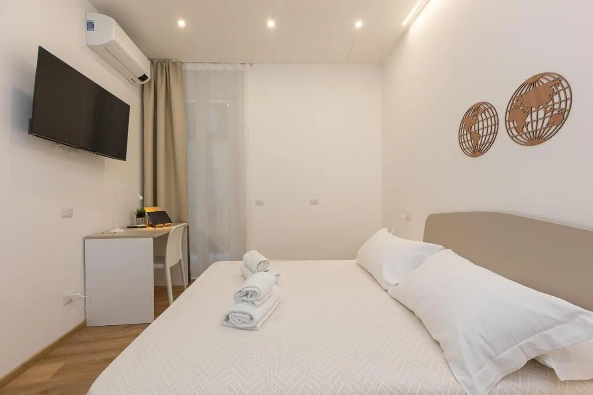 Bed in Colosseum Holidays - Three-Bedroom Apartment