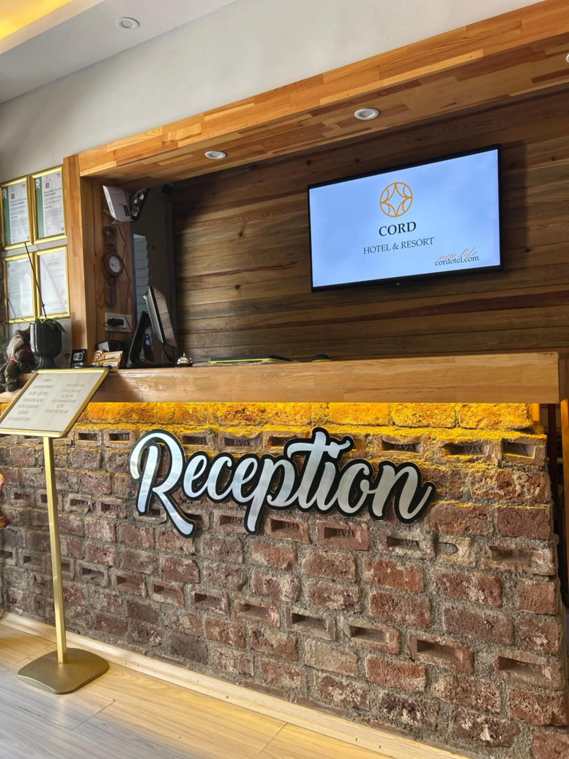 Property logo or sign in Cord Hotel & Resort