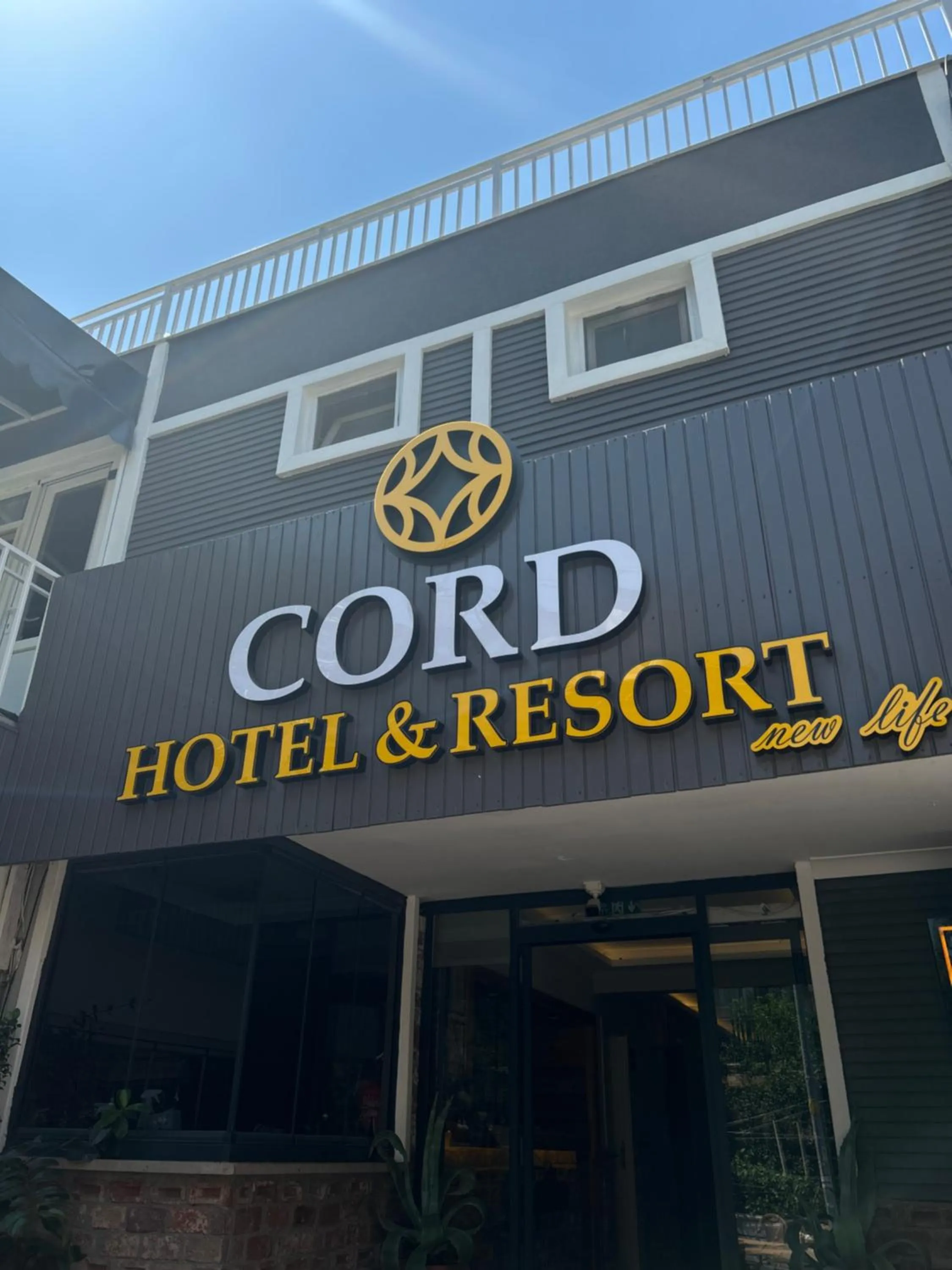 Property logo or sign in Cord Hotel & Resort