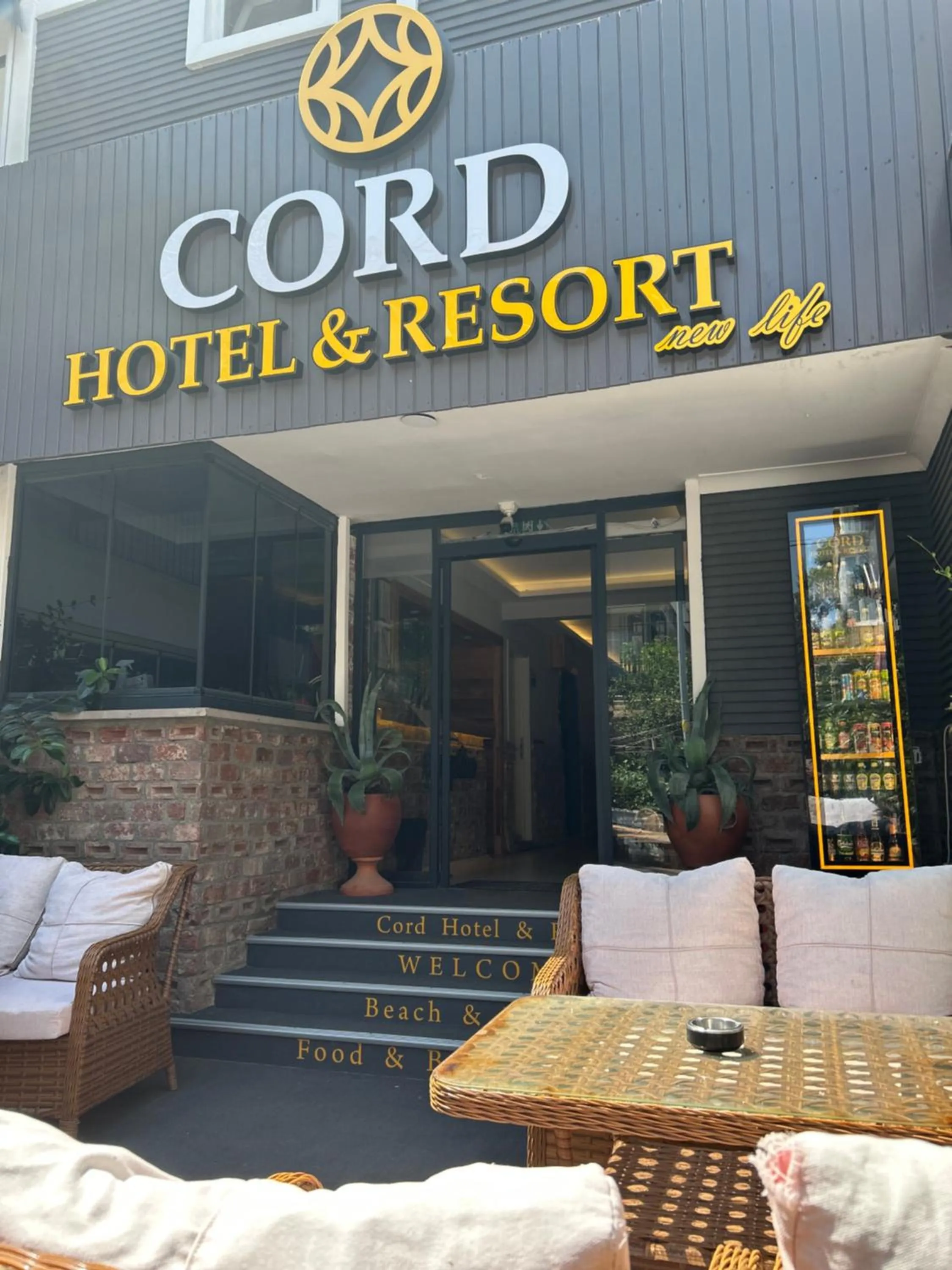 Property logo or sign in Cord Hotel & Resort