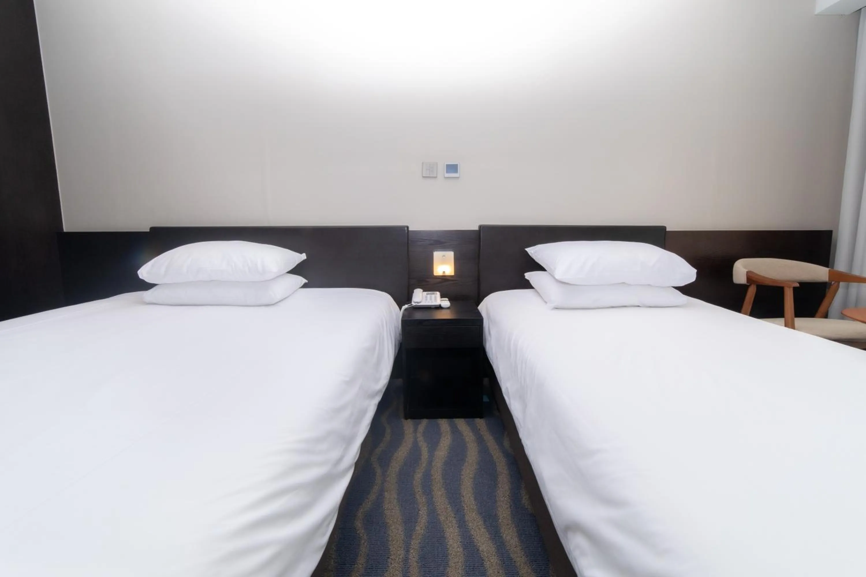 Bed in J-Grand Hotel