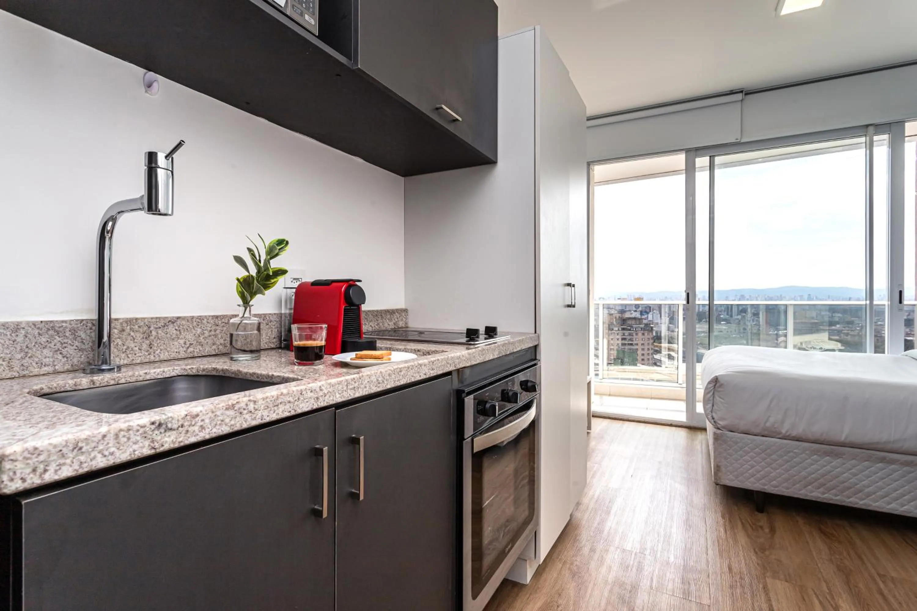 Kitchen or kitchenette, Bed in Setin Downtown Praca da Sé by Viva - Prédio completo com piscina perto de estação de metrô no Centro de São Paulo