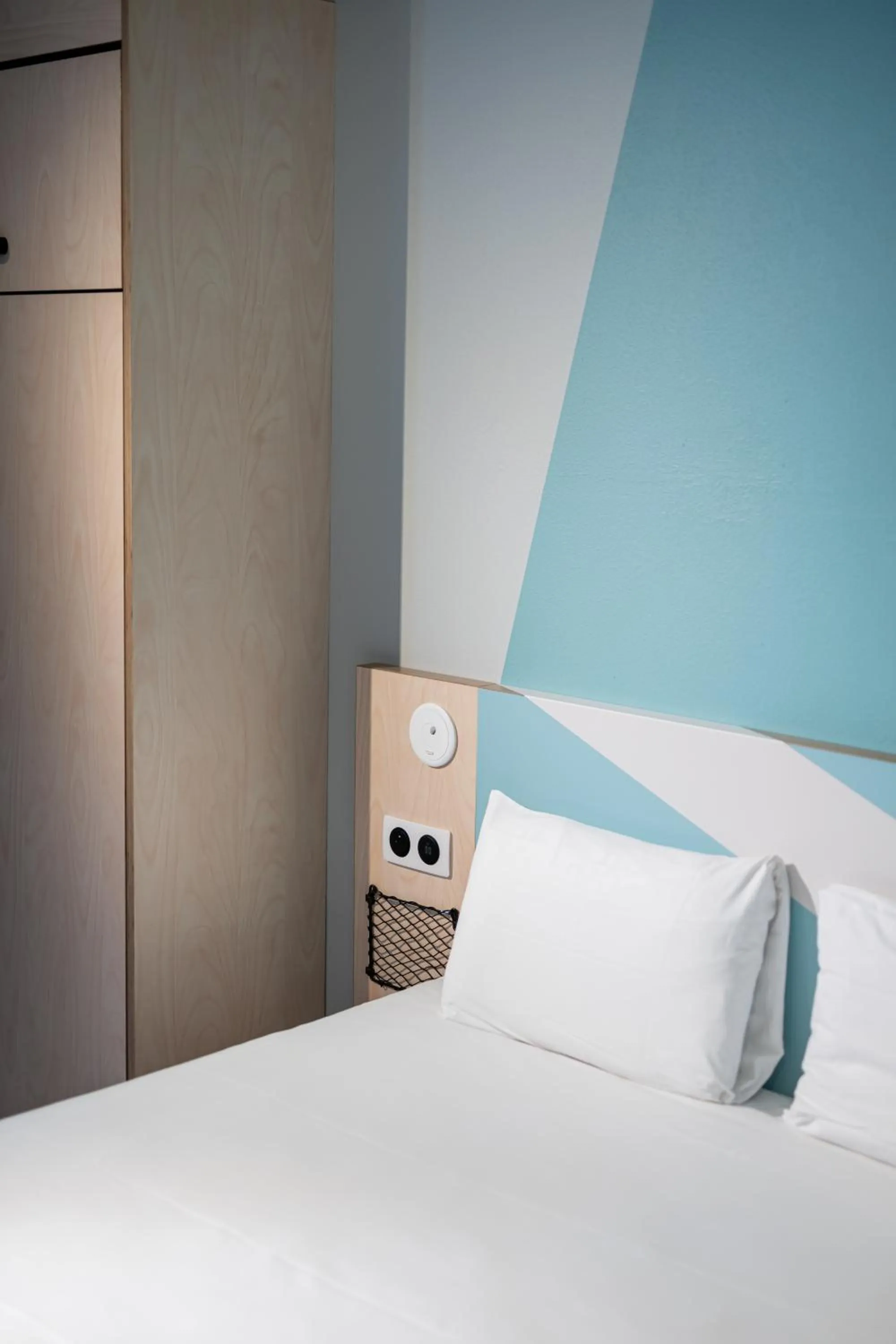 Bed in Ibis Budget Lyon Caluire Cité Internationale