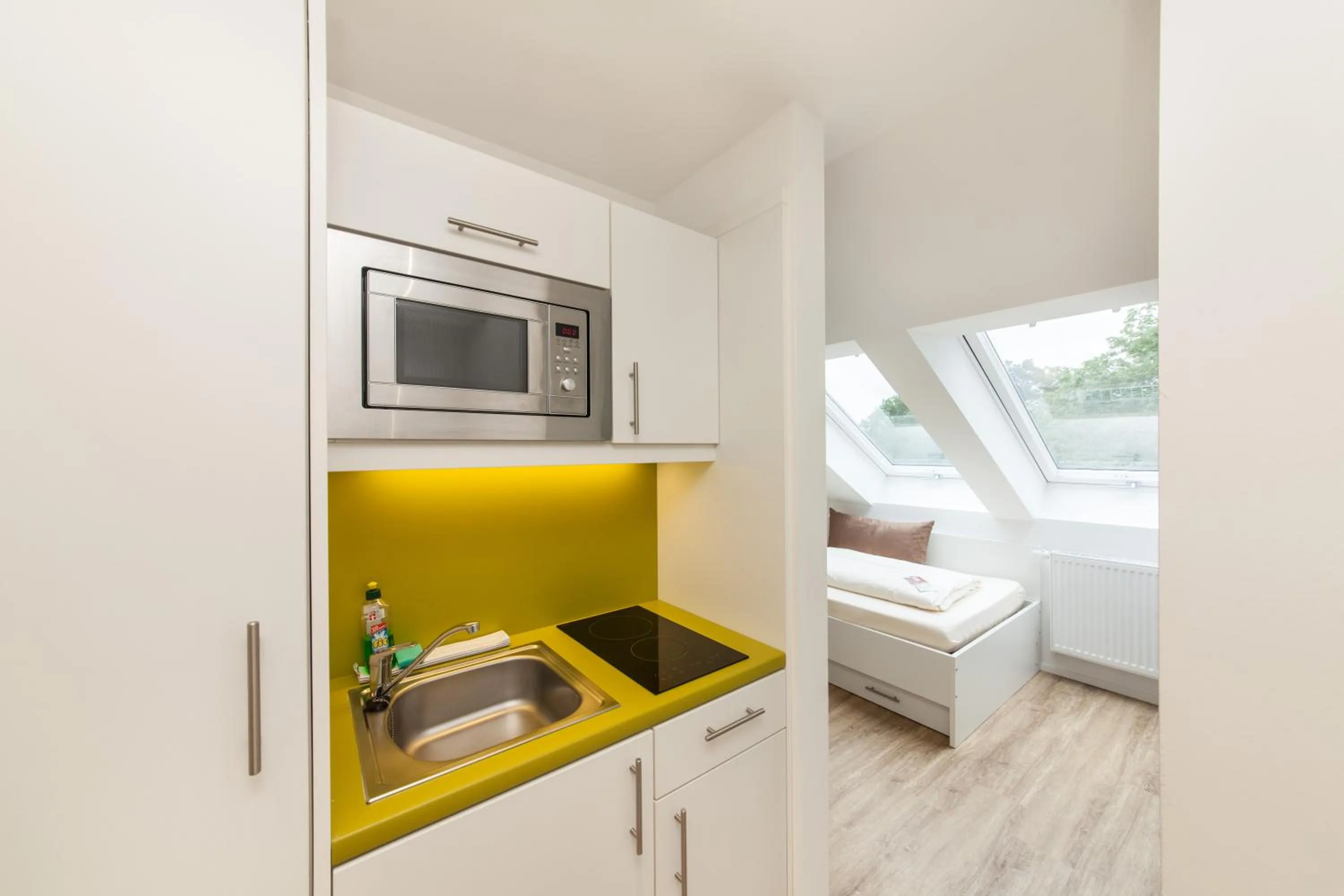 Kitchen or kitchenette in acora Fürth Living the City