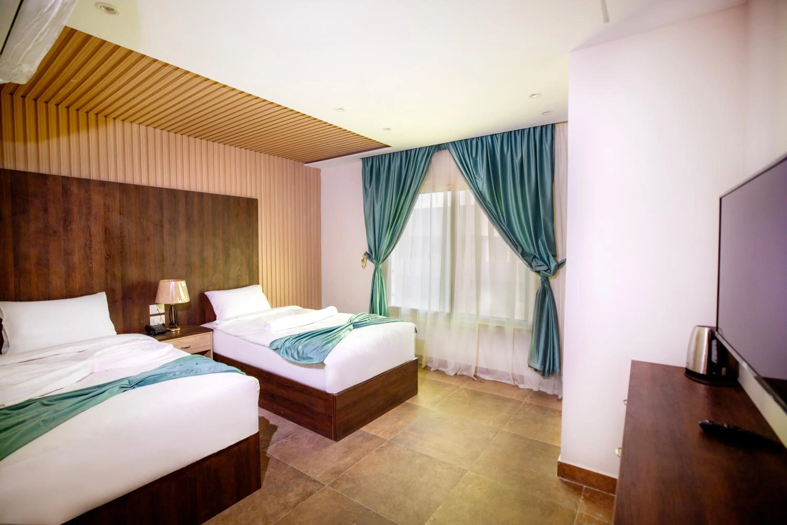 Communal lounge/ TV room, Bed in Blue Pyramids Eyes Hotel