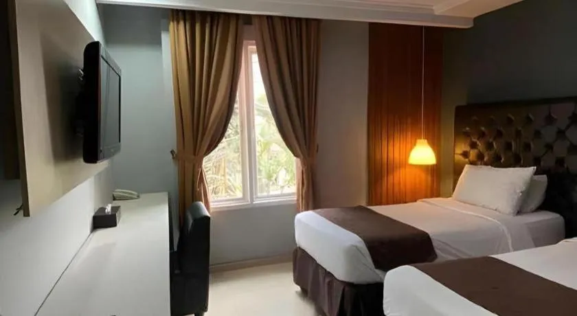 Bed in Rizen Premiere Hotel