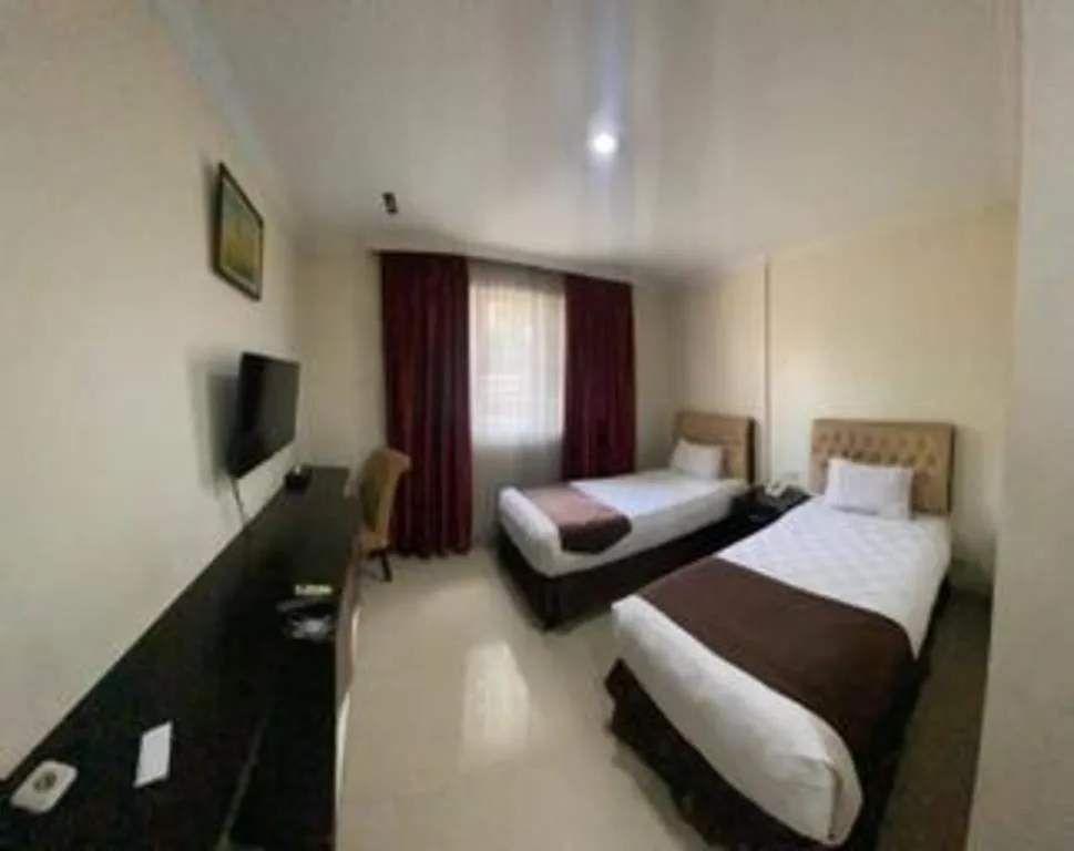 Bed in Rizen Premiere Hotel