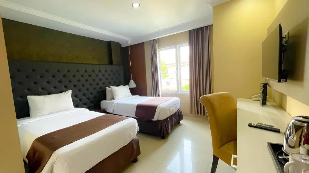 Bed in Rizen Premiere Hotel