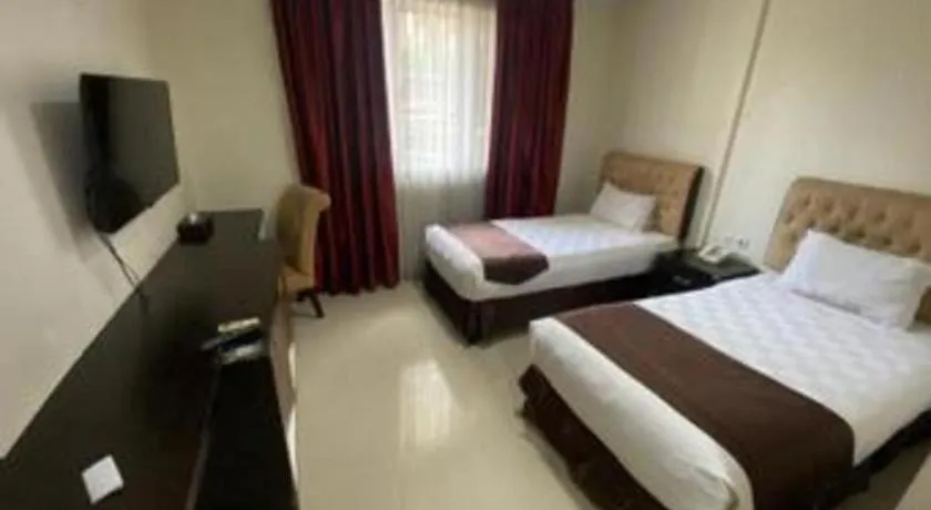 Bed in Rizen Premiere Hotel