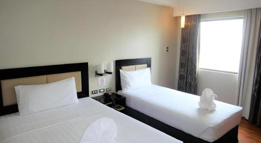 Bed in Mallberry Suites Business Hotel