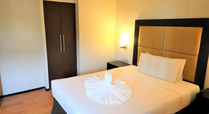 Bed in Mallberry Suites Business Hotel