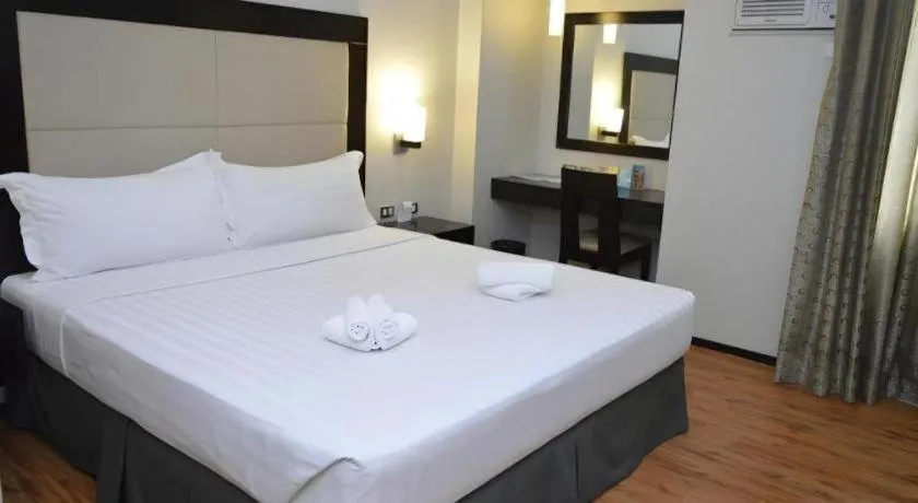 Bed in Mallberry Suites Business Hotel