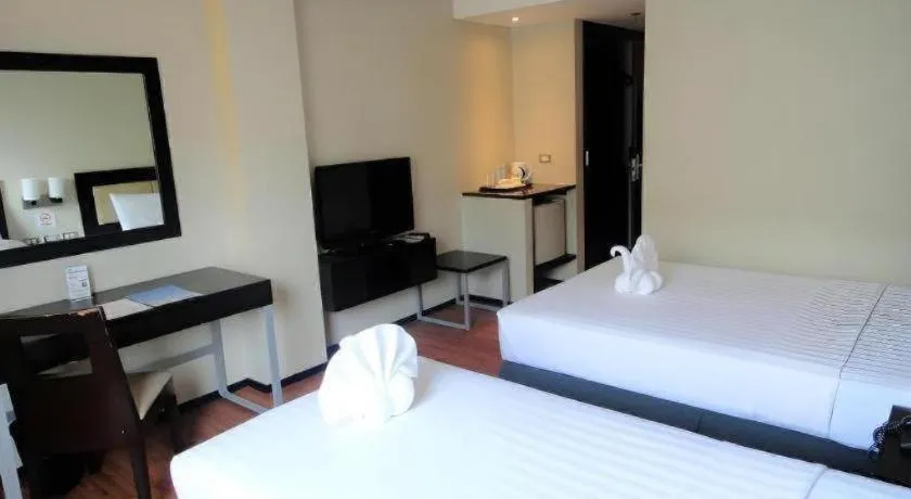 Bed in Mallberry Suites Business Hotel