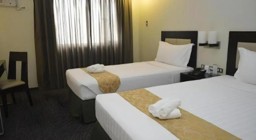 Bed in Mallberry Suites Business Hotel
