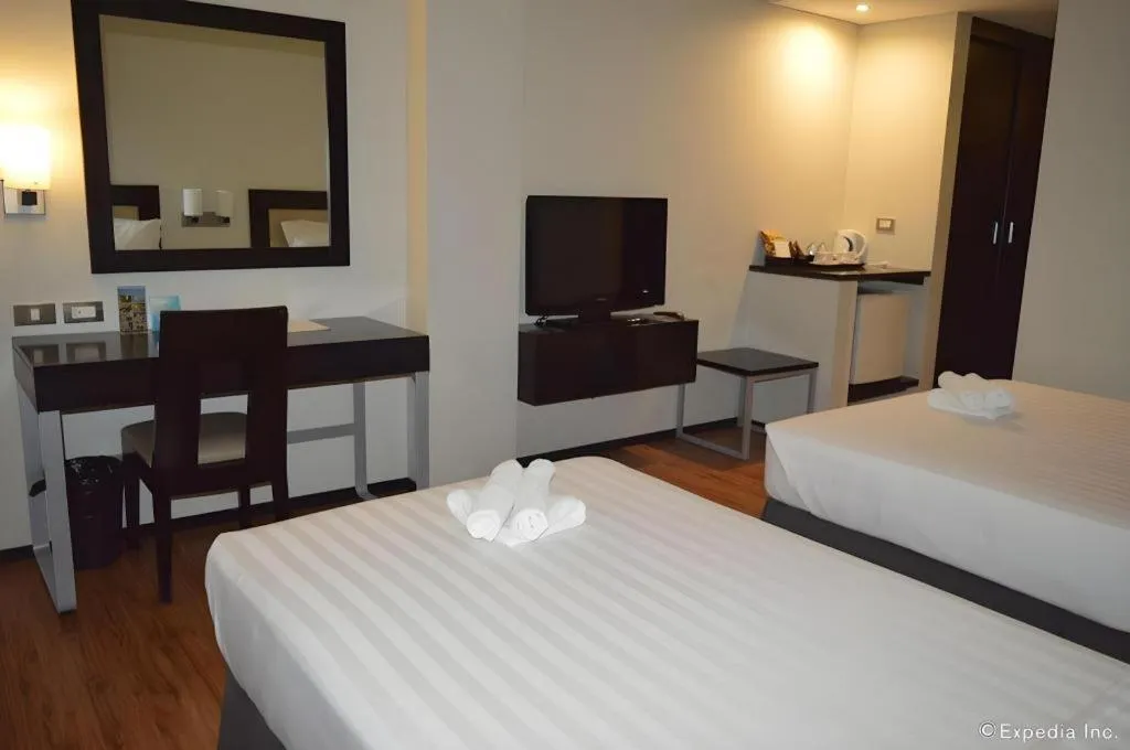 Bed in Mallberry Suites Business Hotel