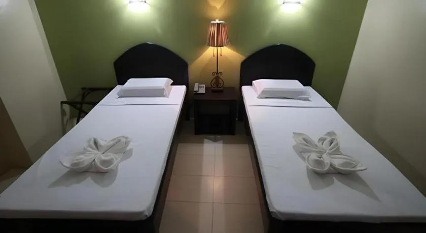 Bed in Sampaguita Suites Plaza Garcia