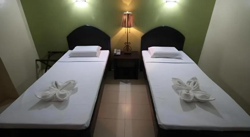 Bed in Sampaguita Suites Plaza Garcia