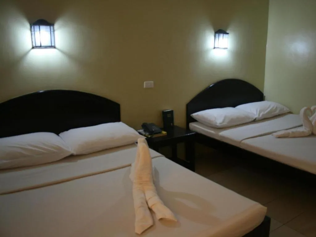 Bed in Sampaguita Suites Plaza Garcia