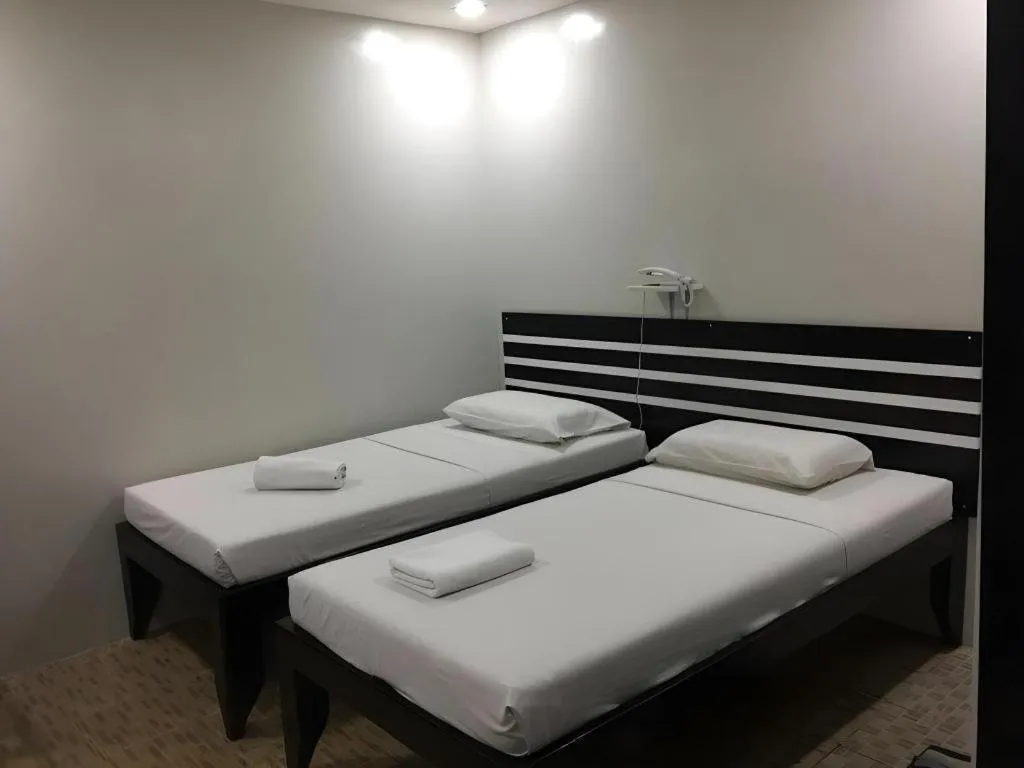 Bed in Sampaguita Suites Plaza Garcia