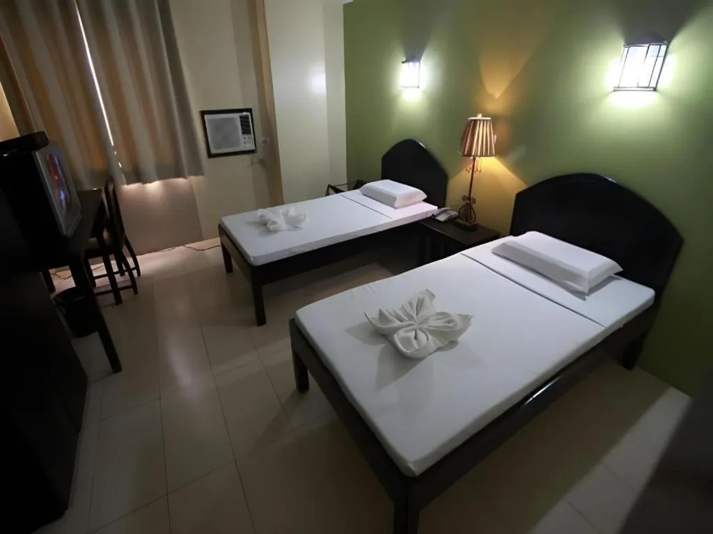 Bed in Sampaguita Suites Plaza Garcia