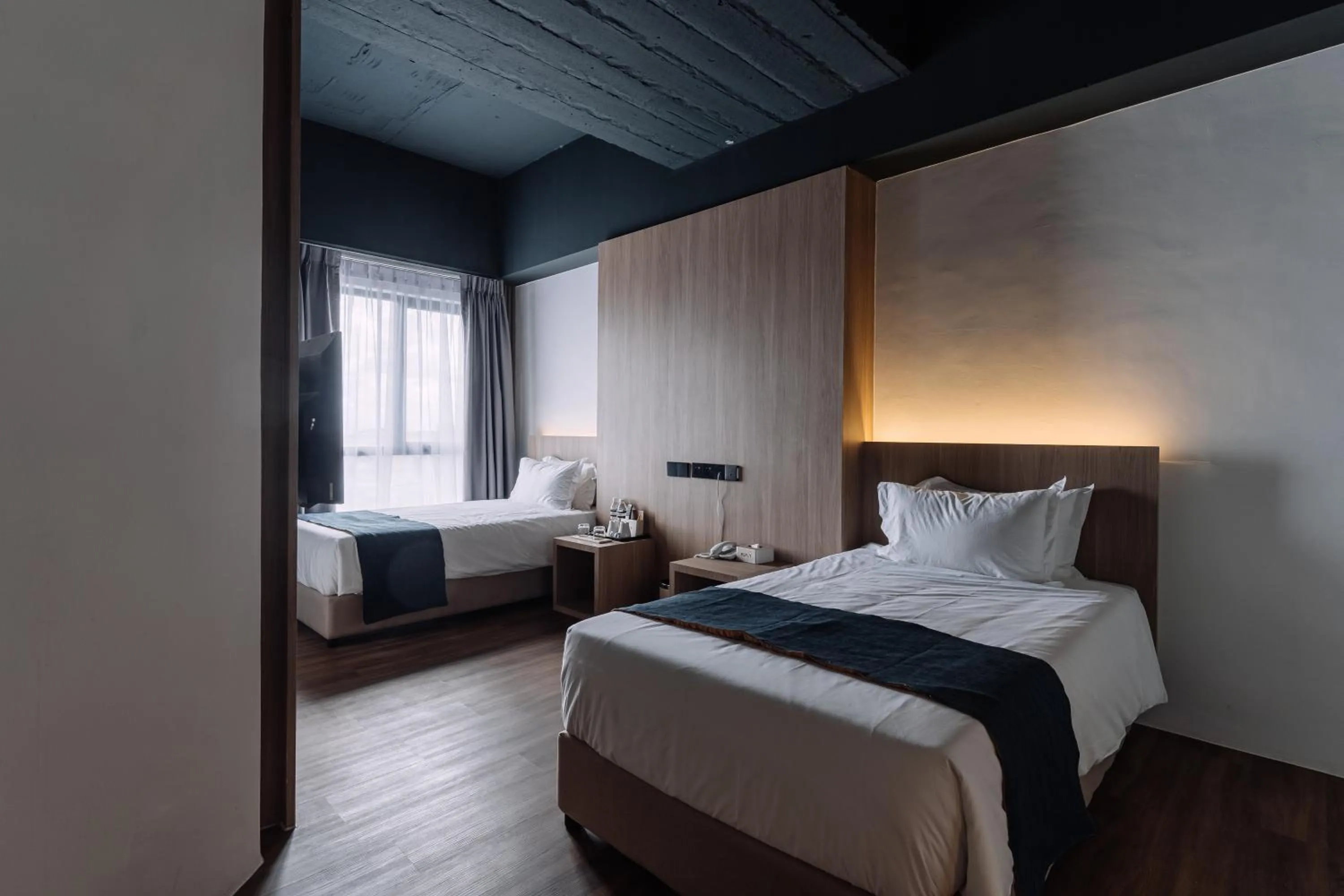 Bed in Impiana by Roxy Hotel