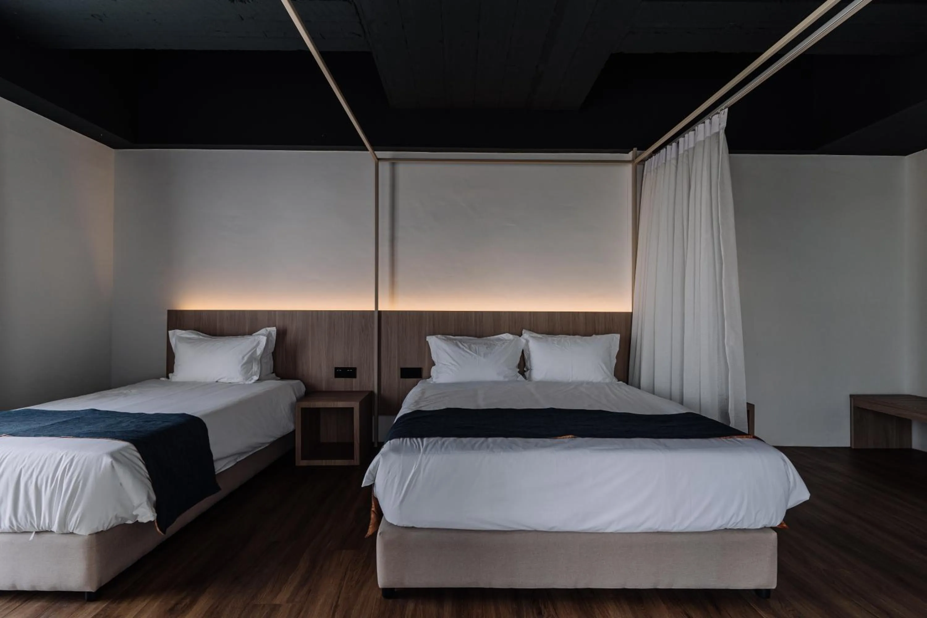 Bed in Impiana by Roxy Hotel