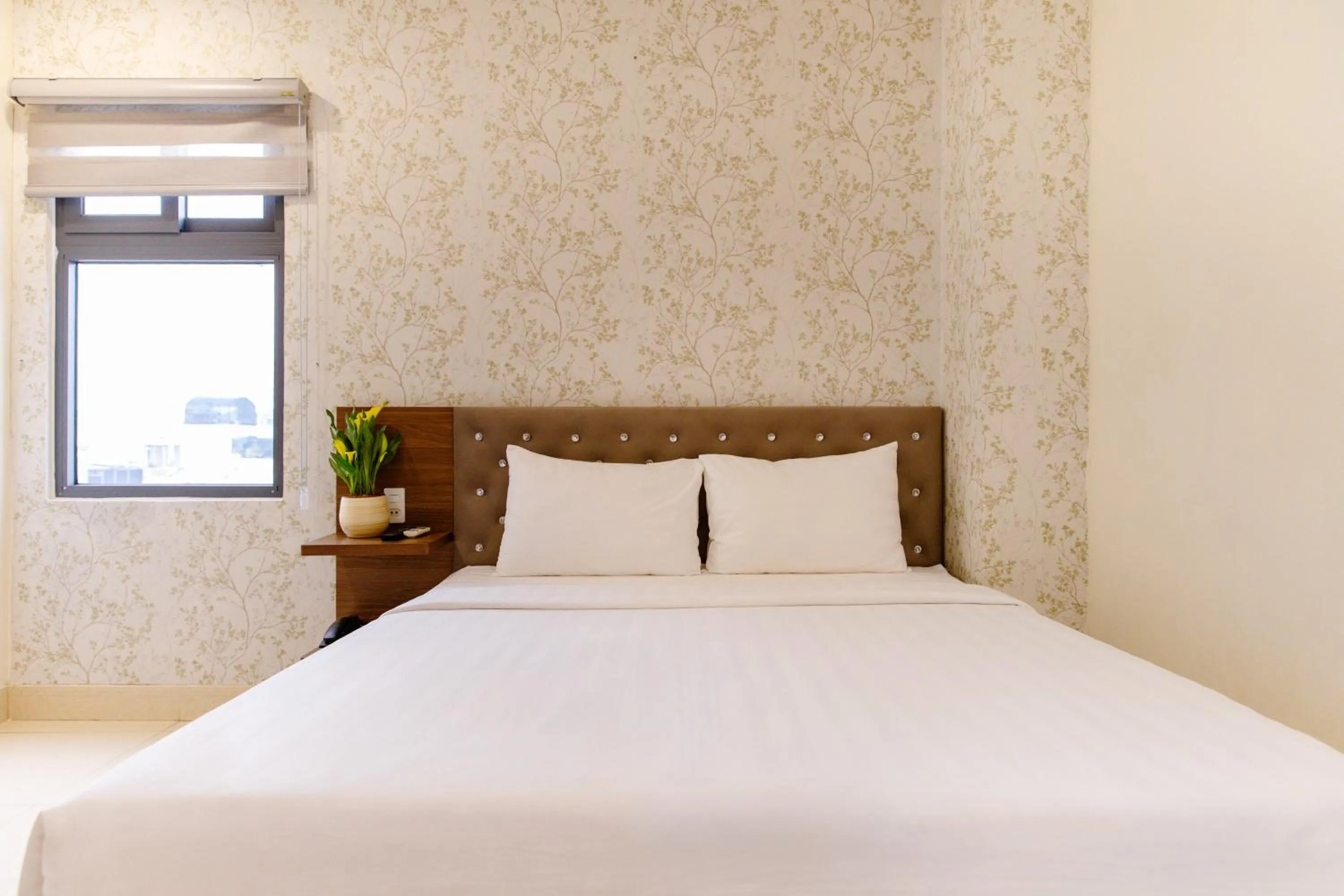 Bed in Boss Palace Hotel