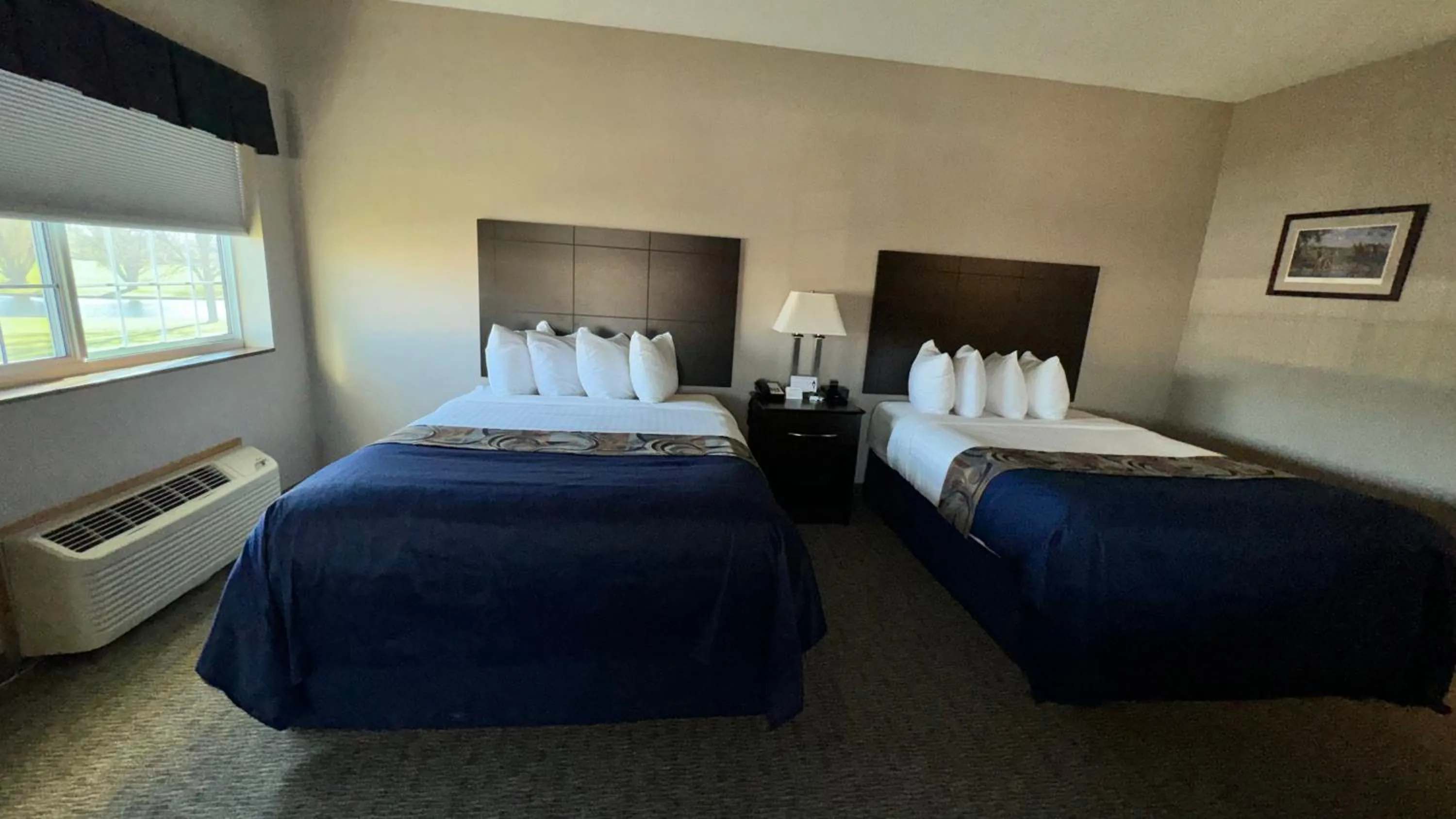 Bed in Garner INN & Suites