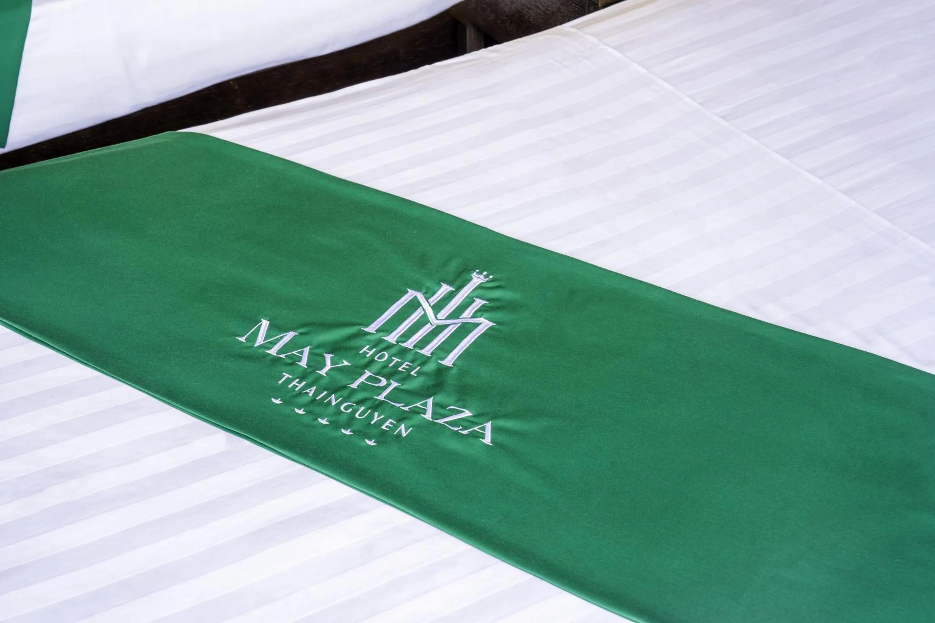 Bed in MAY PLAZA HOTEL