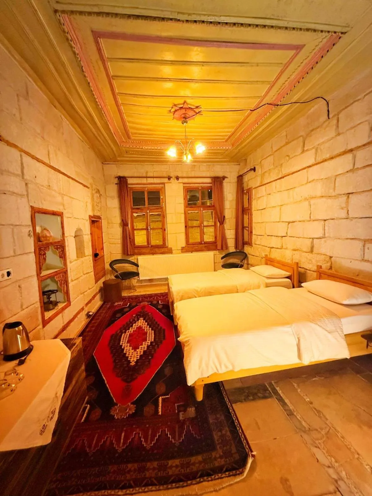 Seating area, Bed in My Cave Suites