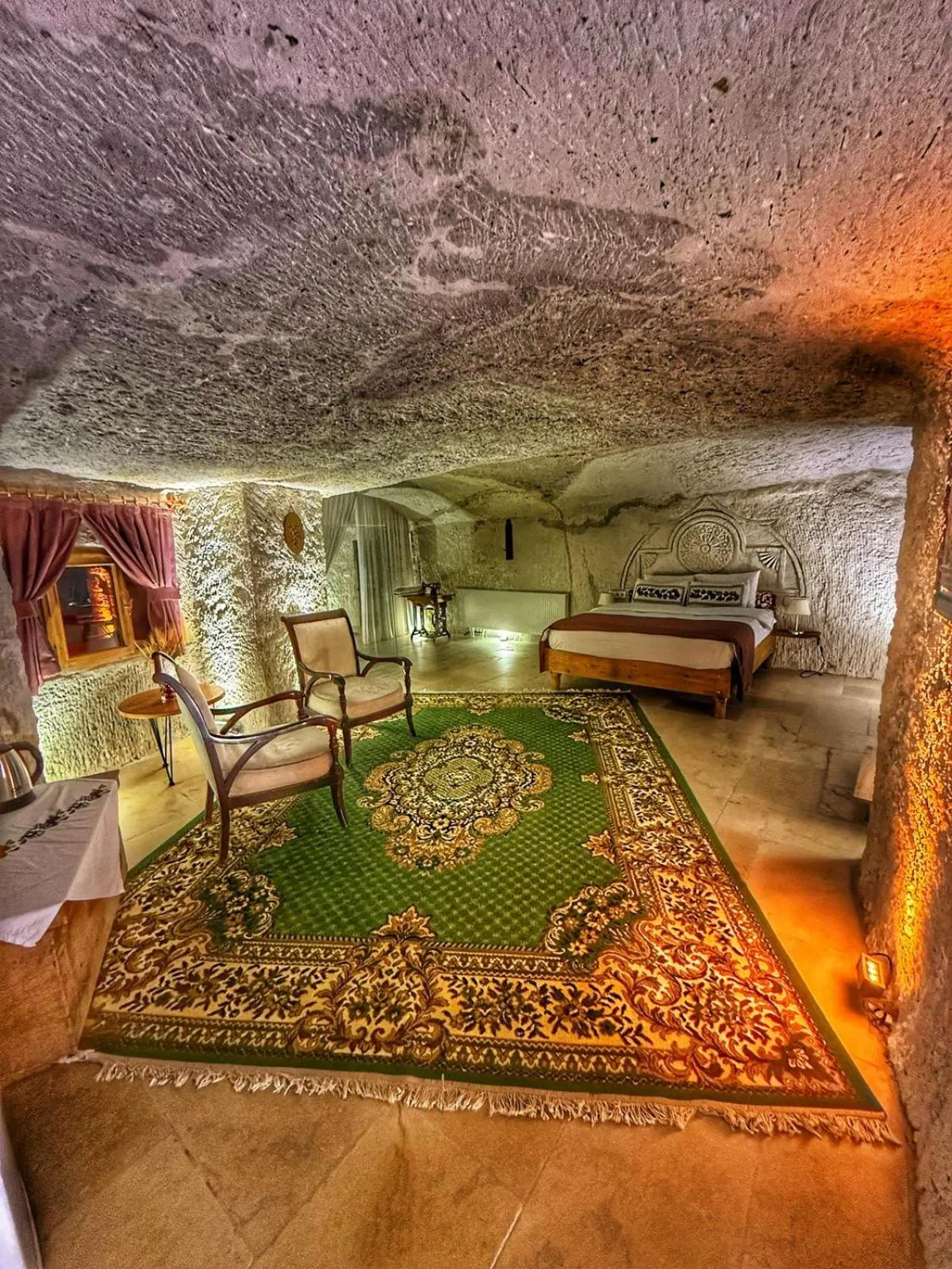 Seating area, Bed in My Cave Suites