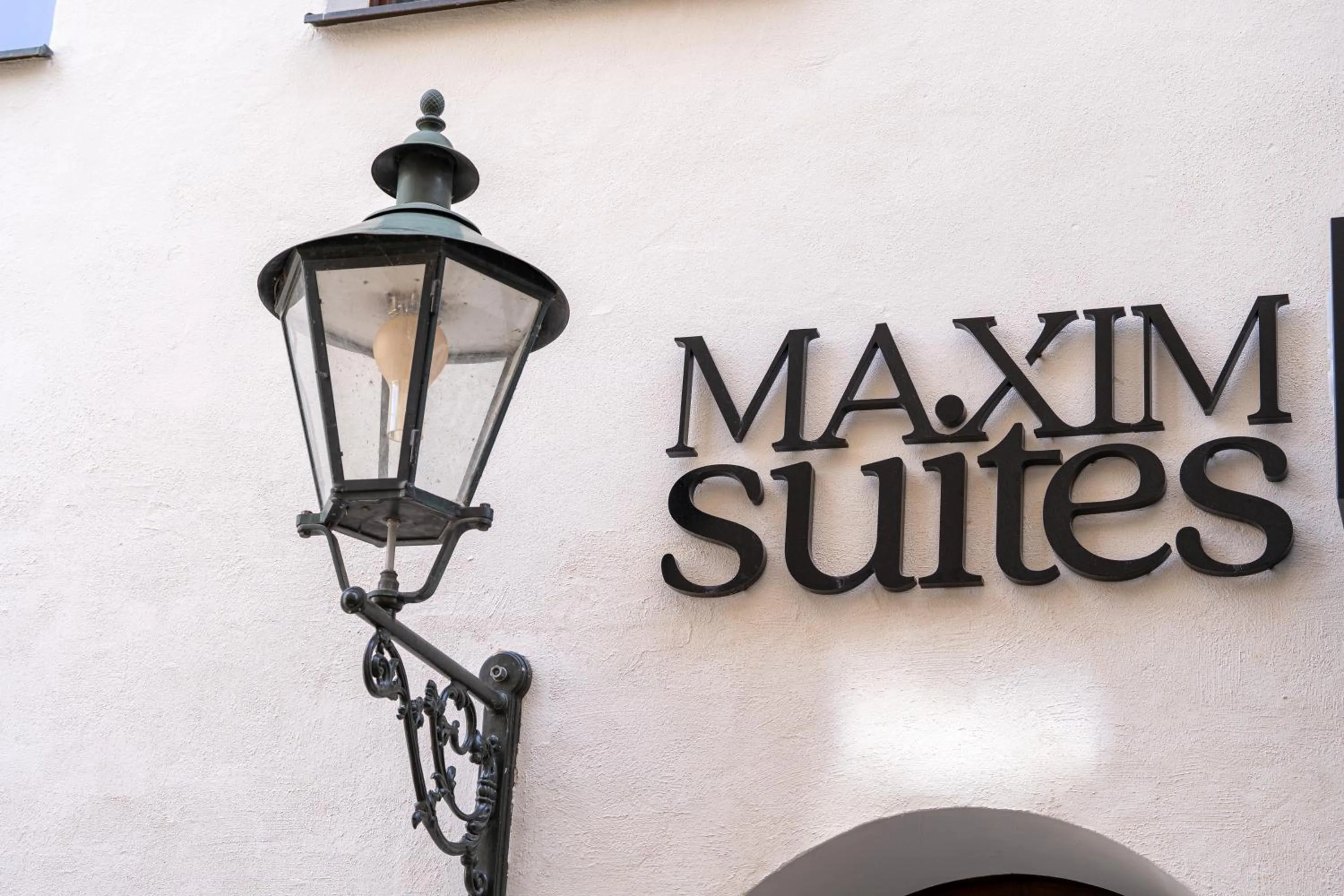 Property logo or sign in Maxim Suites by Elias Holl