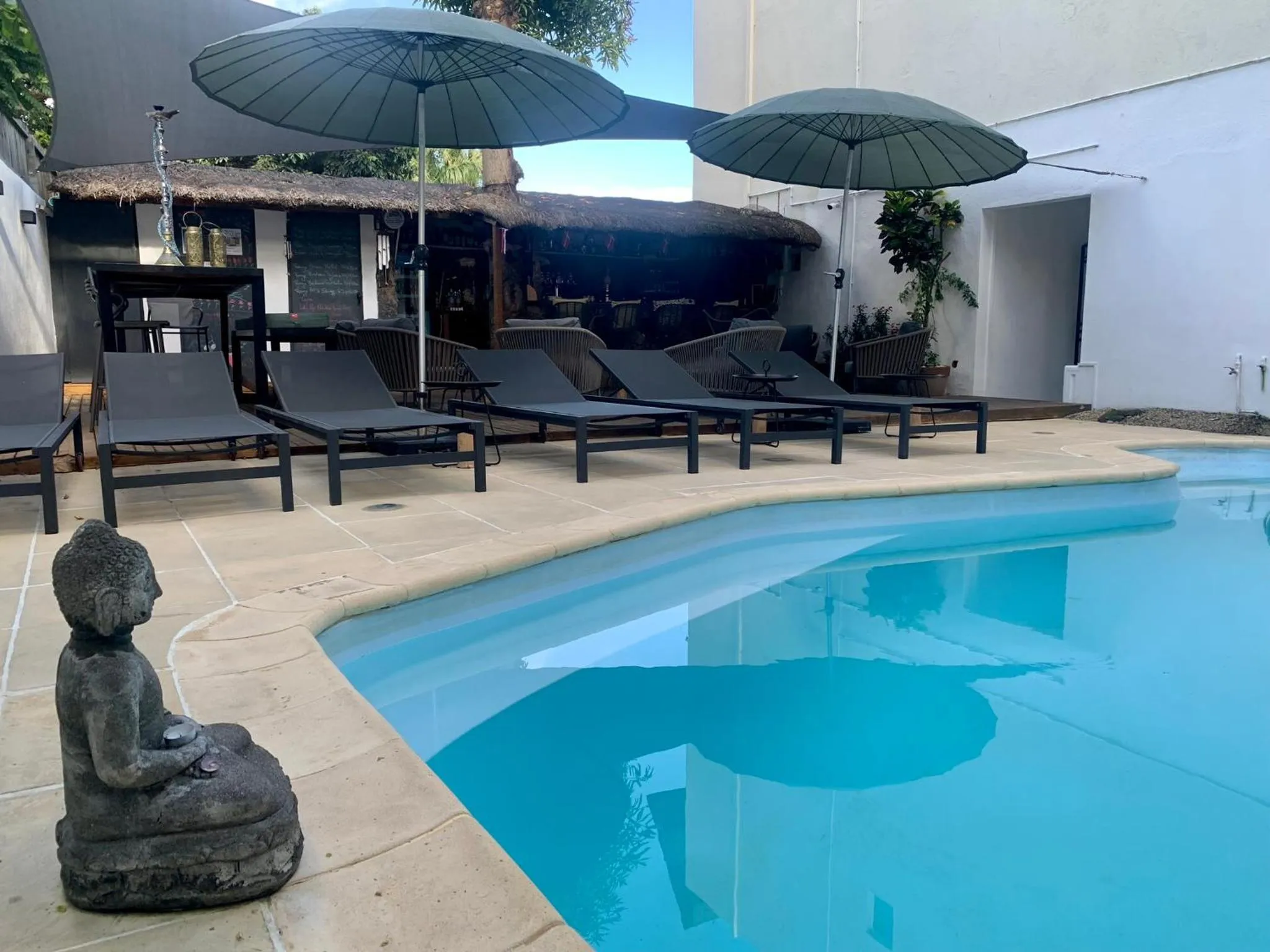 Swimming pool in Cosy Guest House Sous le Badamier