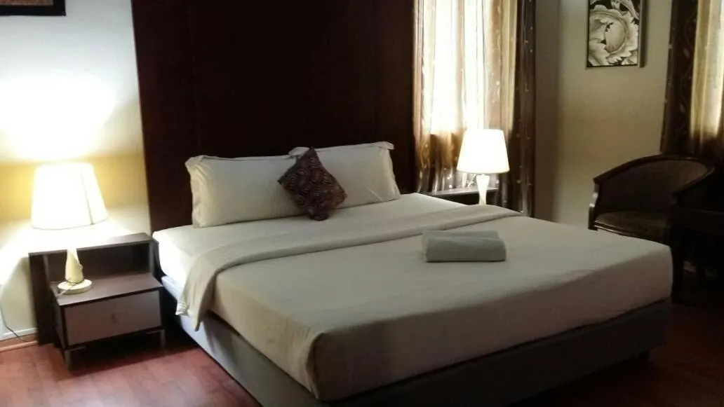 Bed in Ginasuite Hotel