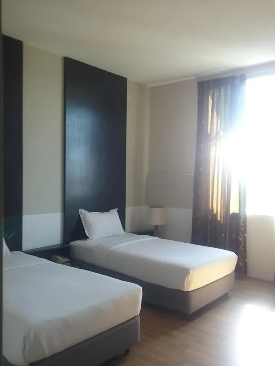 Bed in Ginasuite Hotel