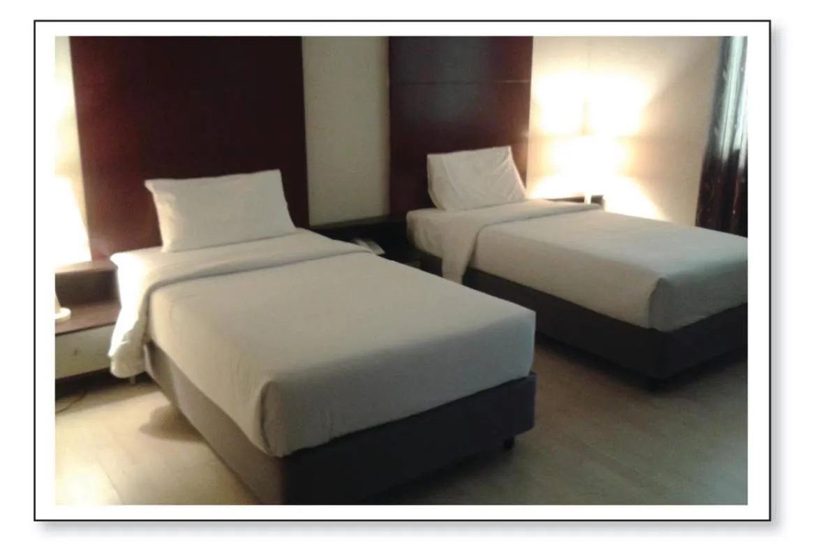 Bed in Ginasuite Hotel