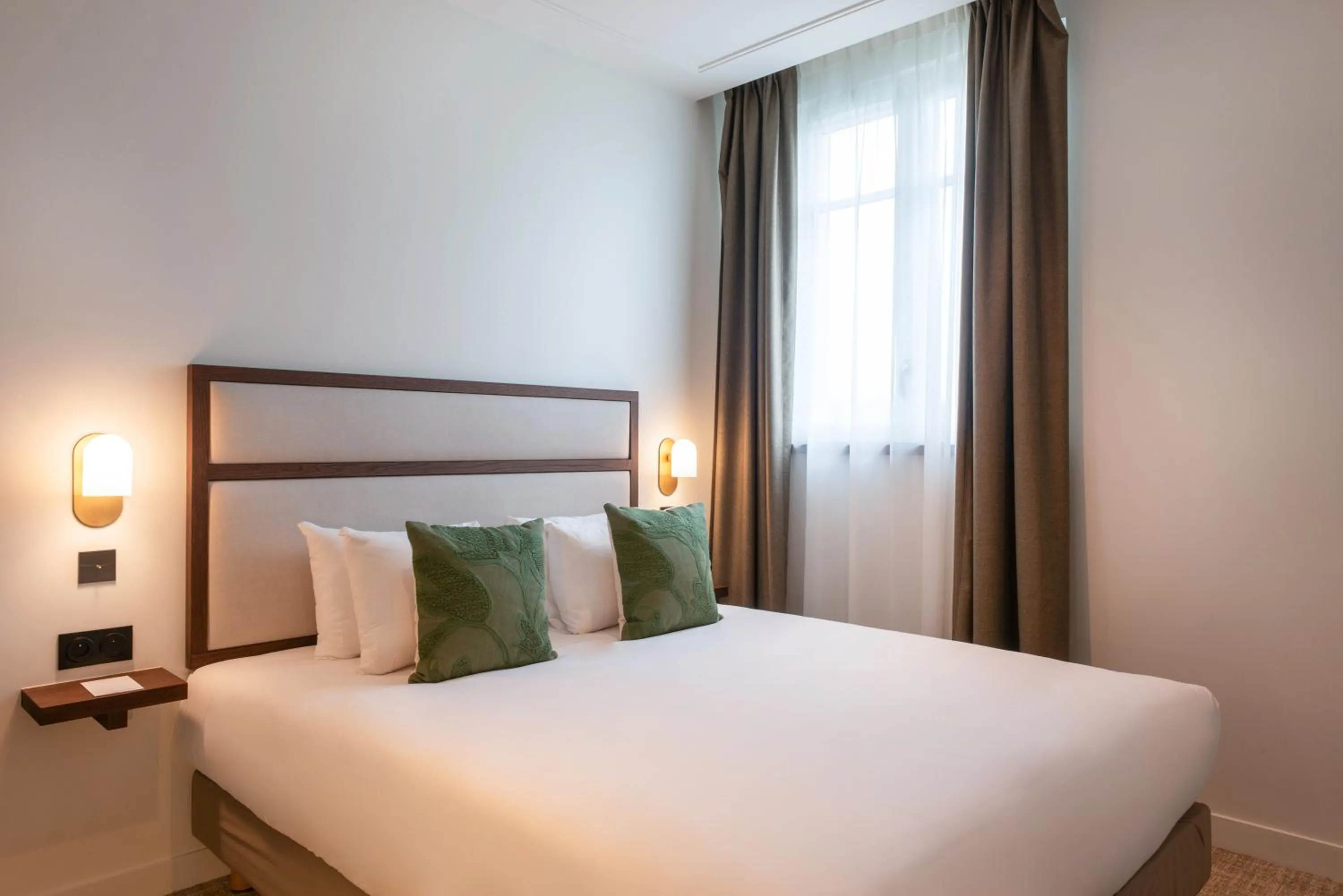 Bed in Le Lampika Hôtel