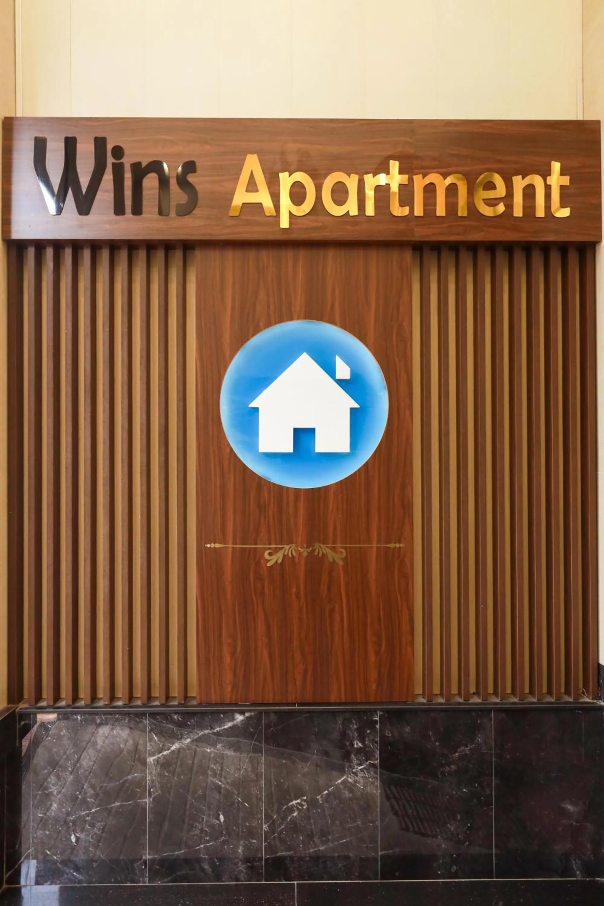 Property logo or sign in Wins Apartment