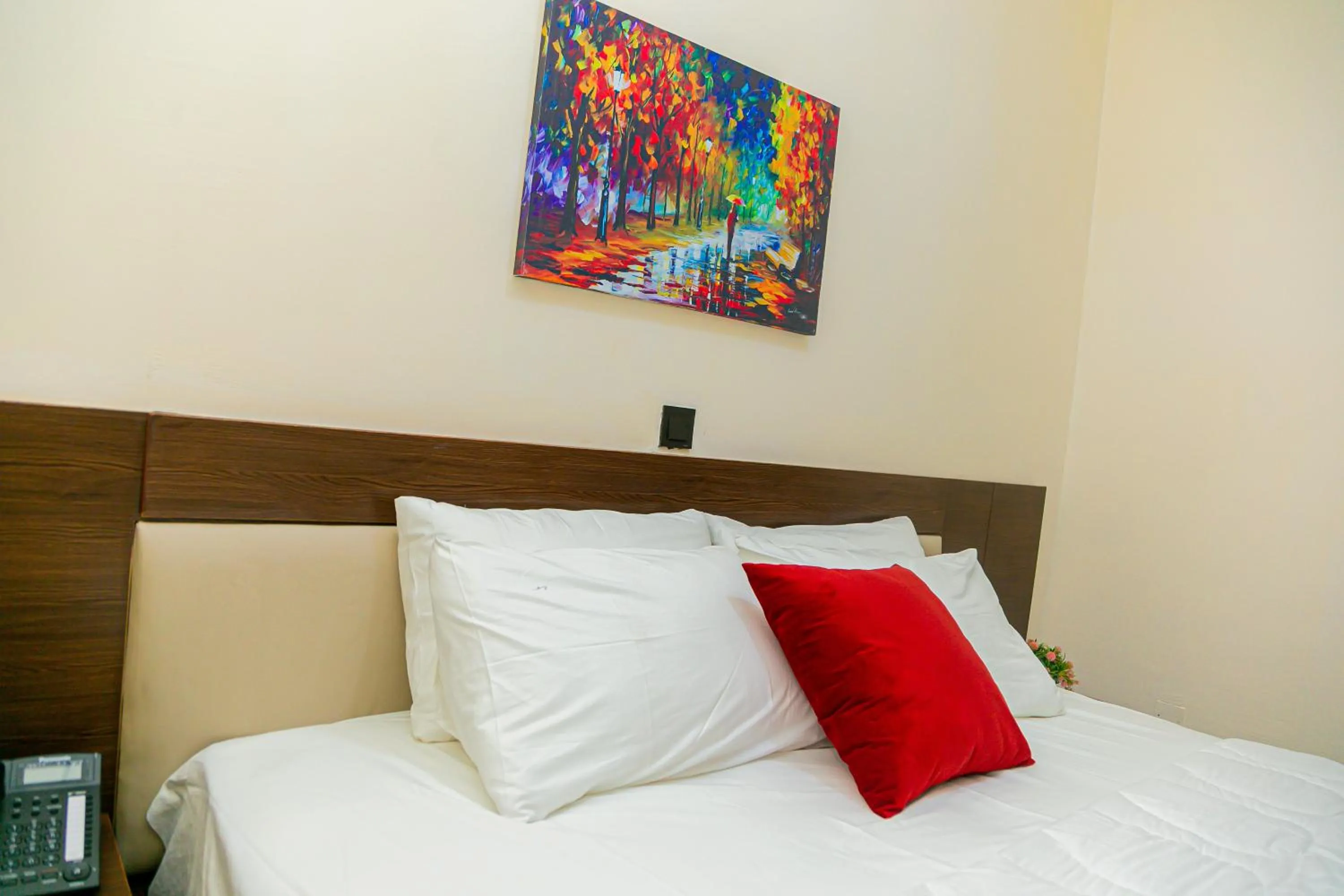 Bed in Fragrance Apartments and Suites