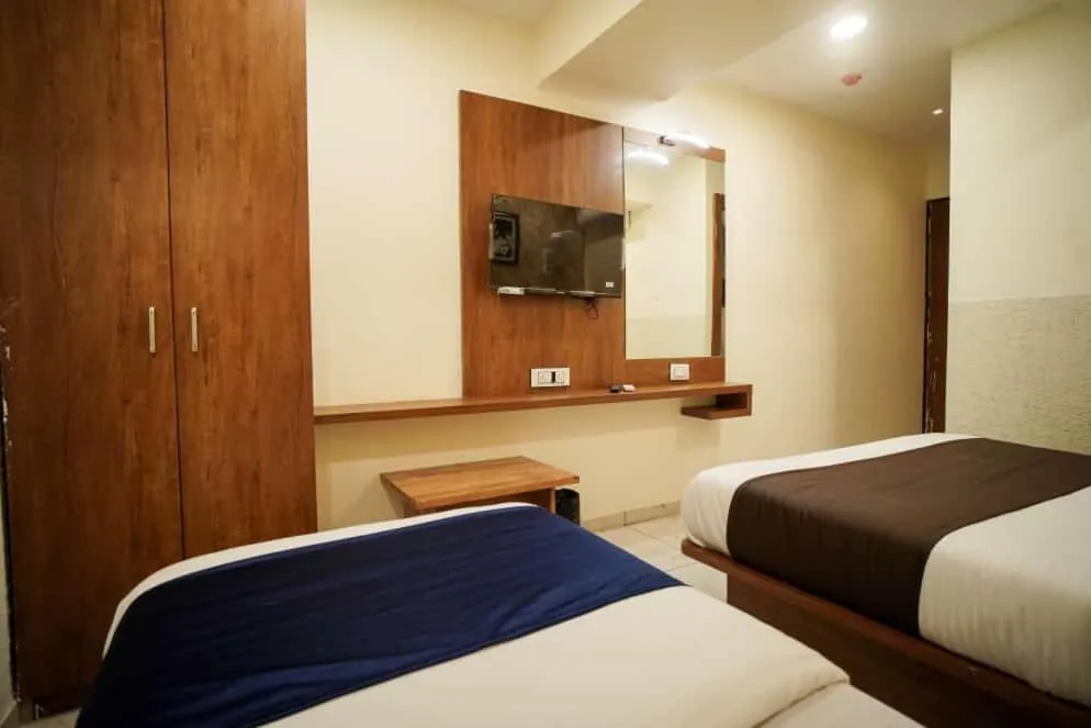 Communal lounge/ TV room, Bed in Hotel Mahaveer