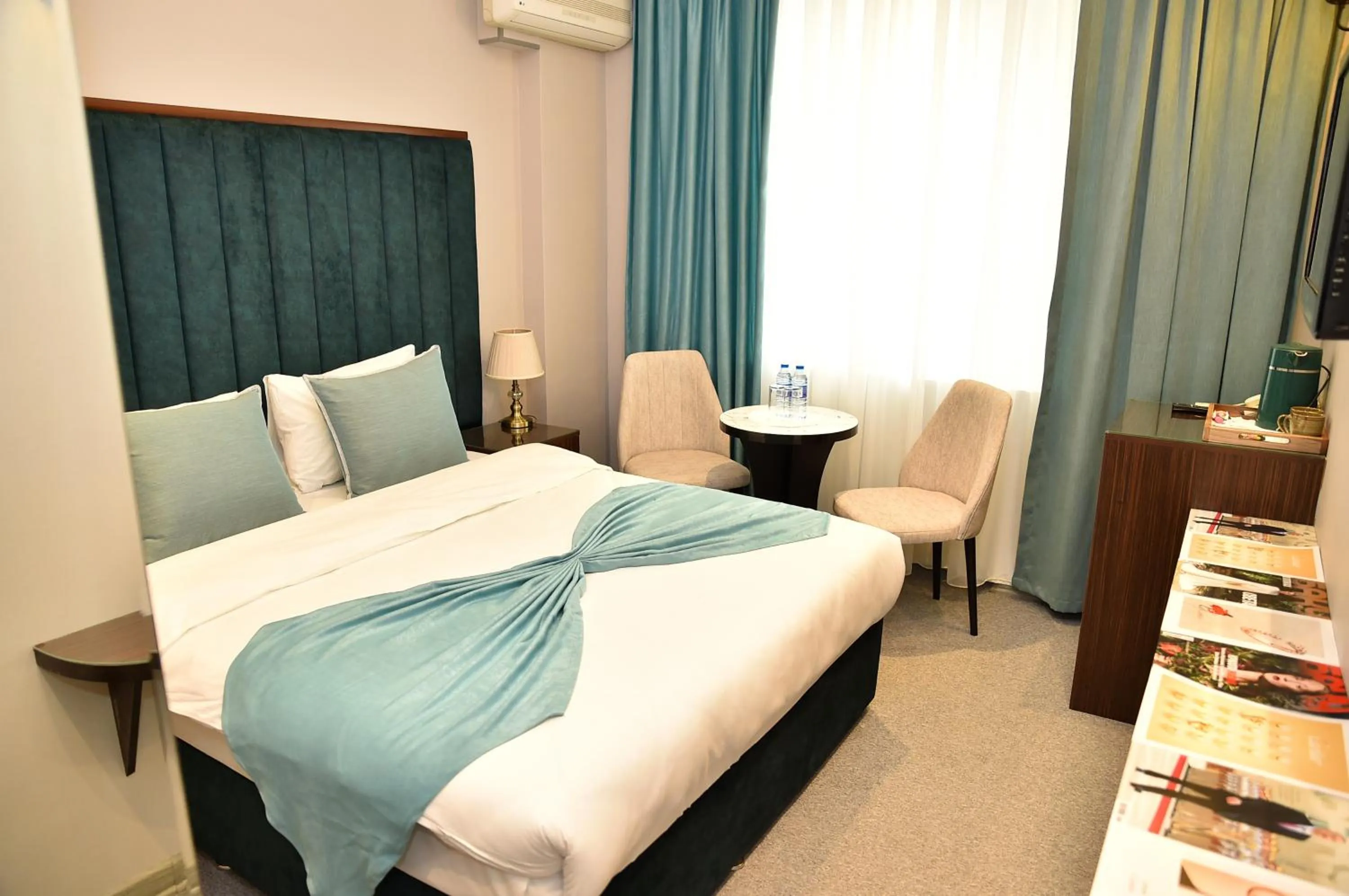 Bed in Karat Inn Boutique Hotel