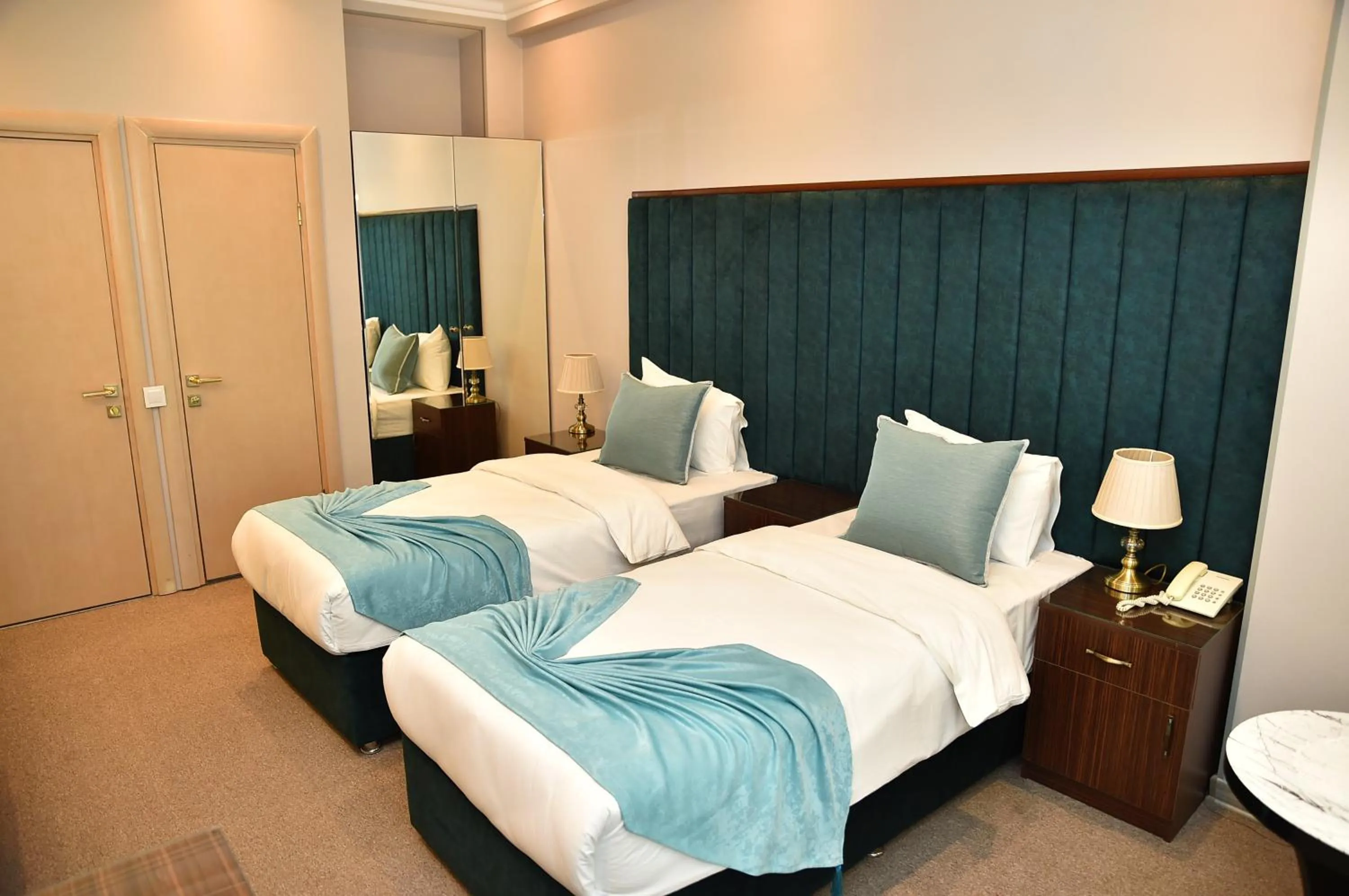 Bed in Karat Inn Boutique Hotel