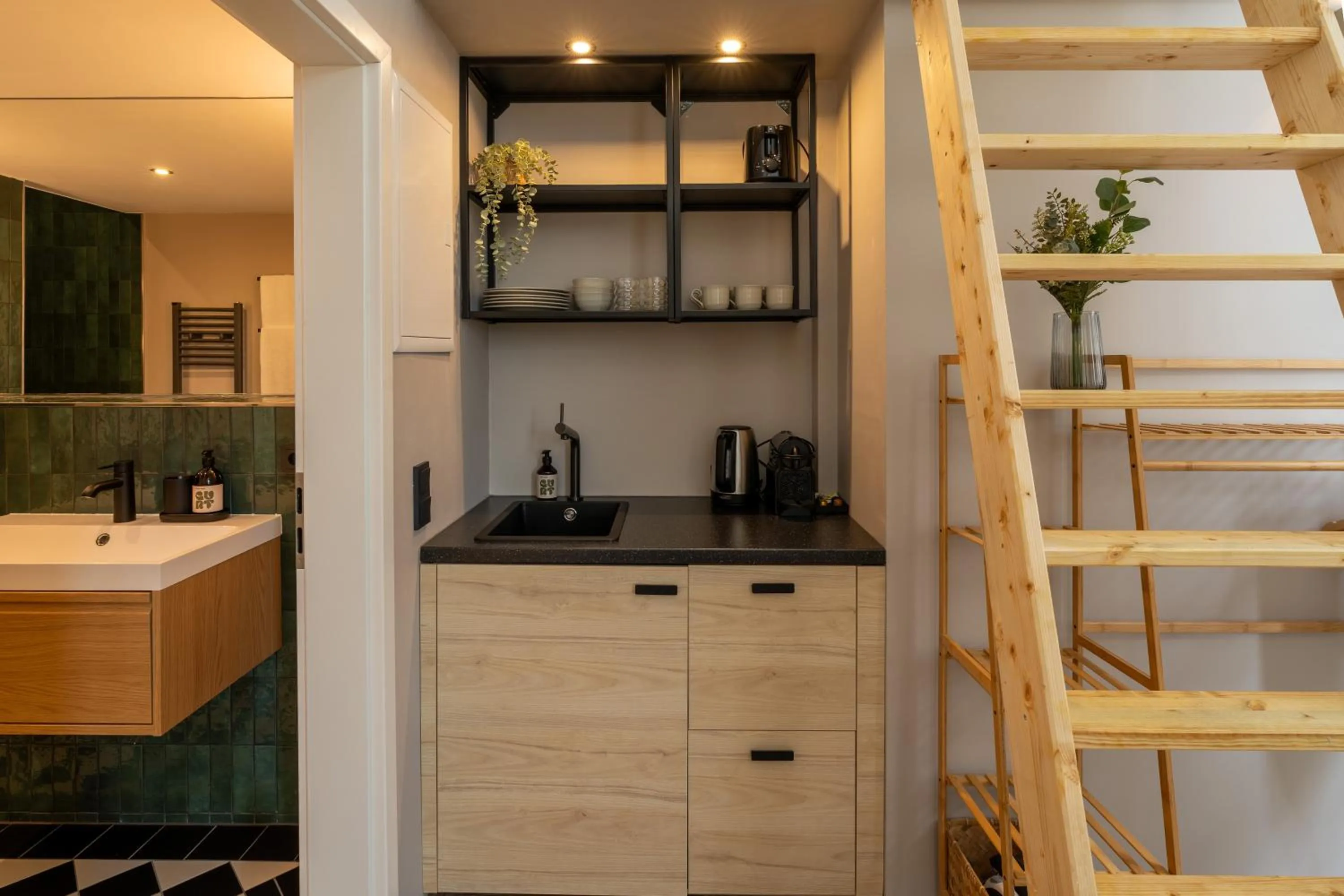 kitchen in The Charming by Curt Suites