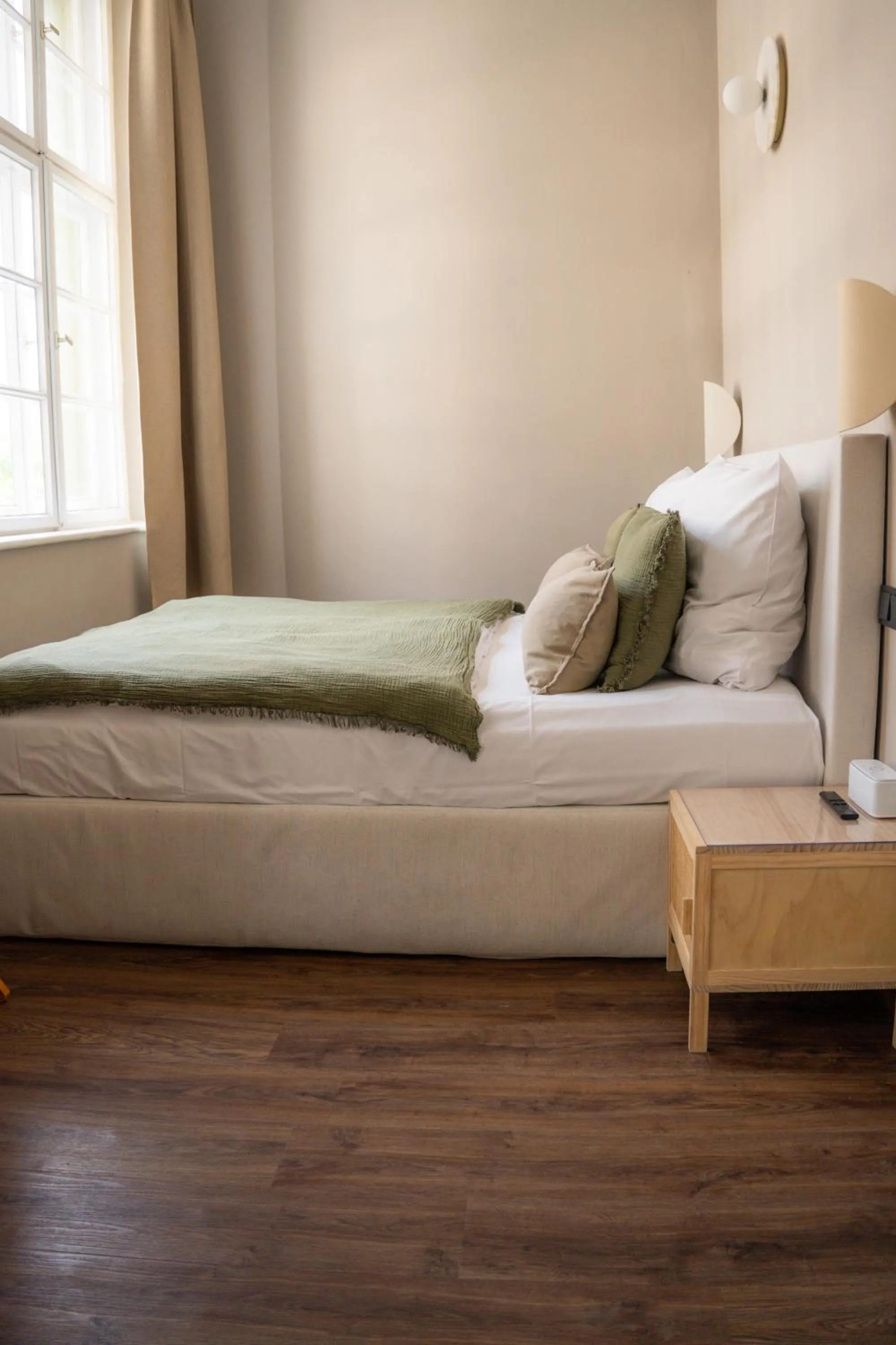 Bed in The Charming by Curt Suites