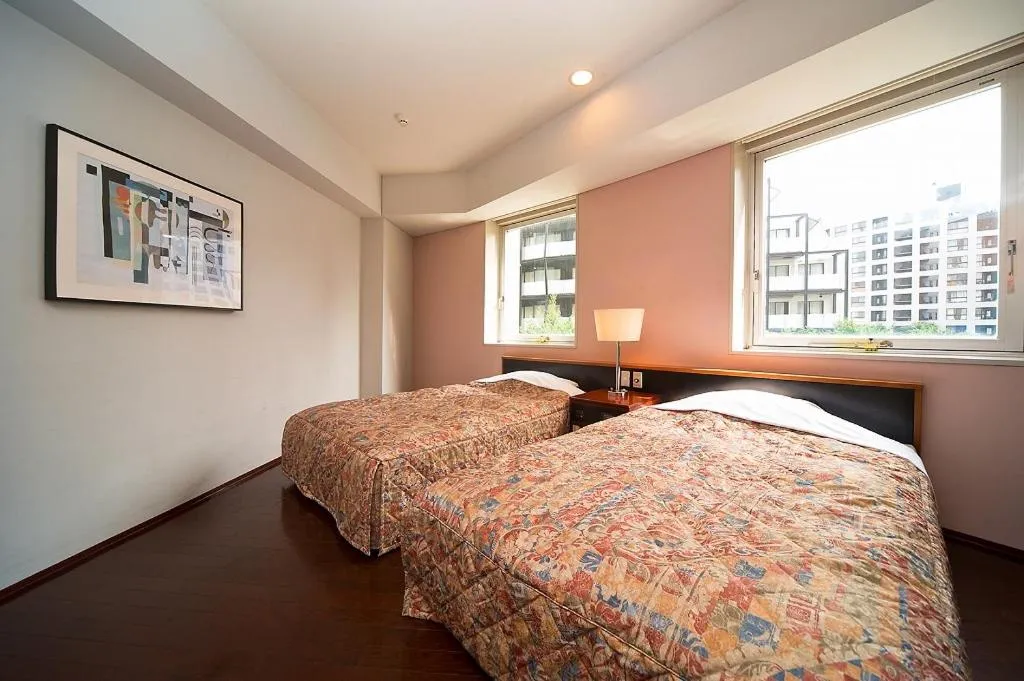 Bed in The Residential Suites Fukuoka