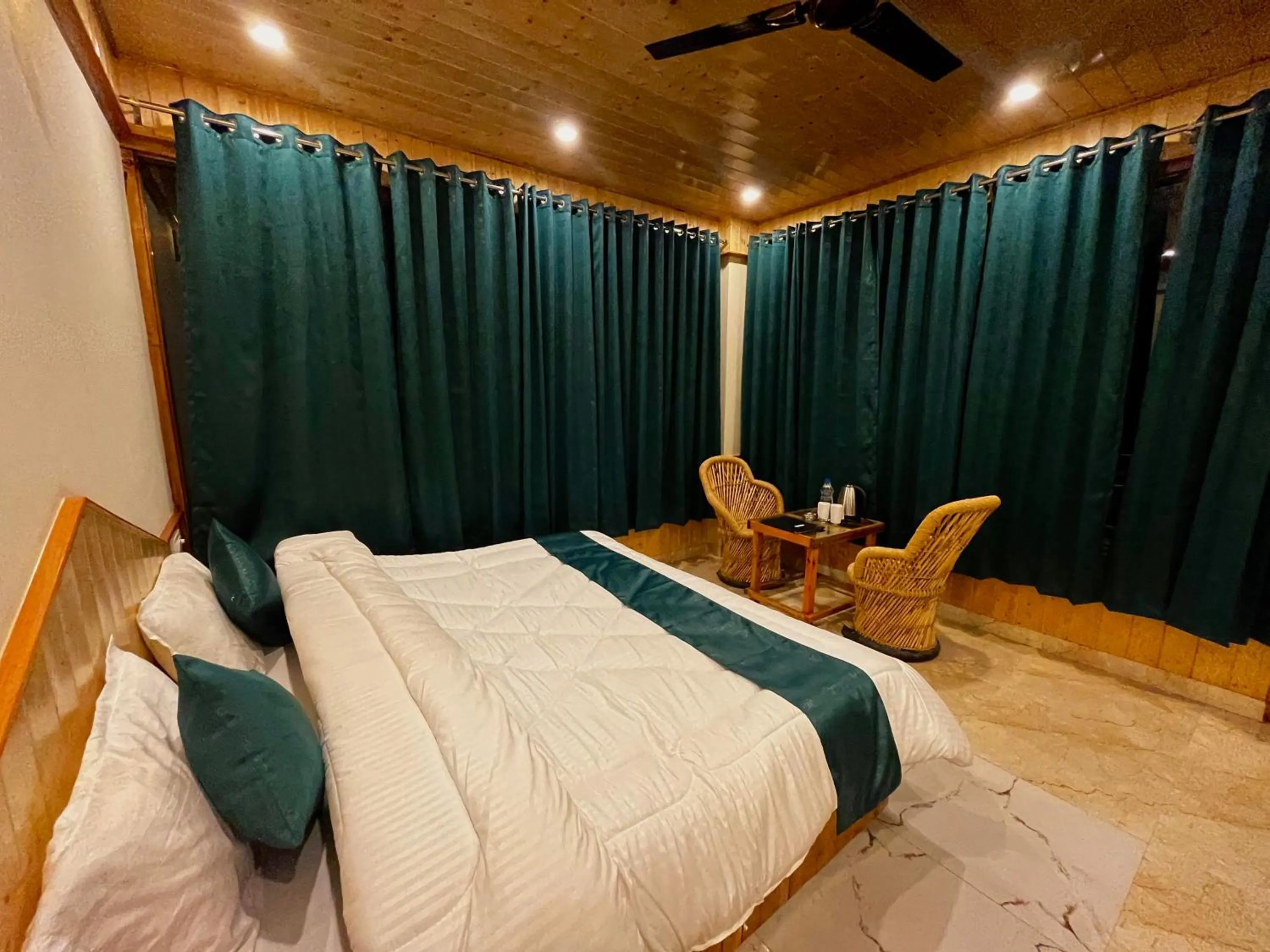 Seating area, Bed in Hotel Mid Orchard Kasol -River Side