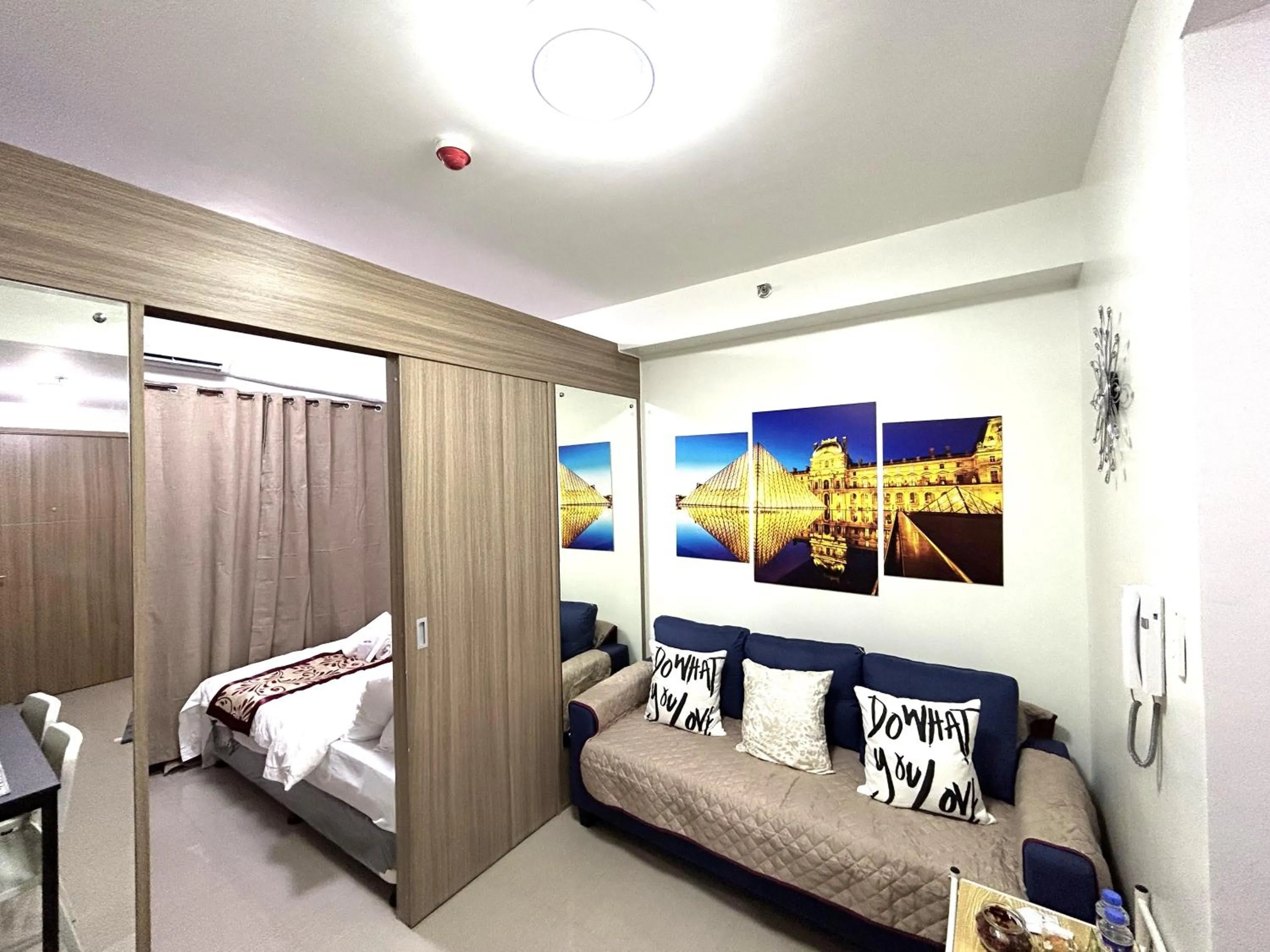 Living room, Bed in Shore Residences MOA Dynastel Staycation