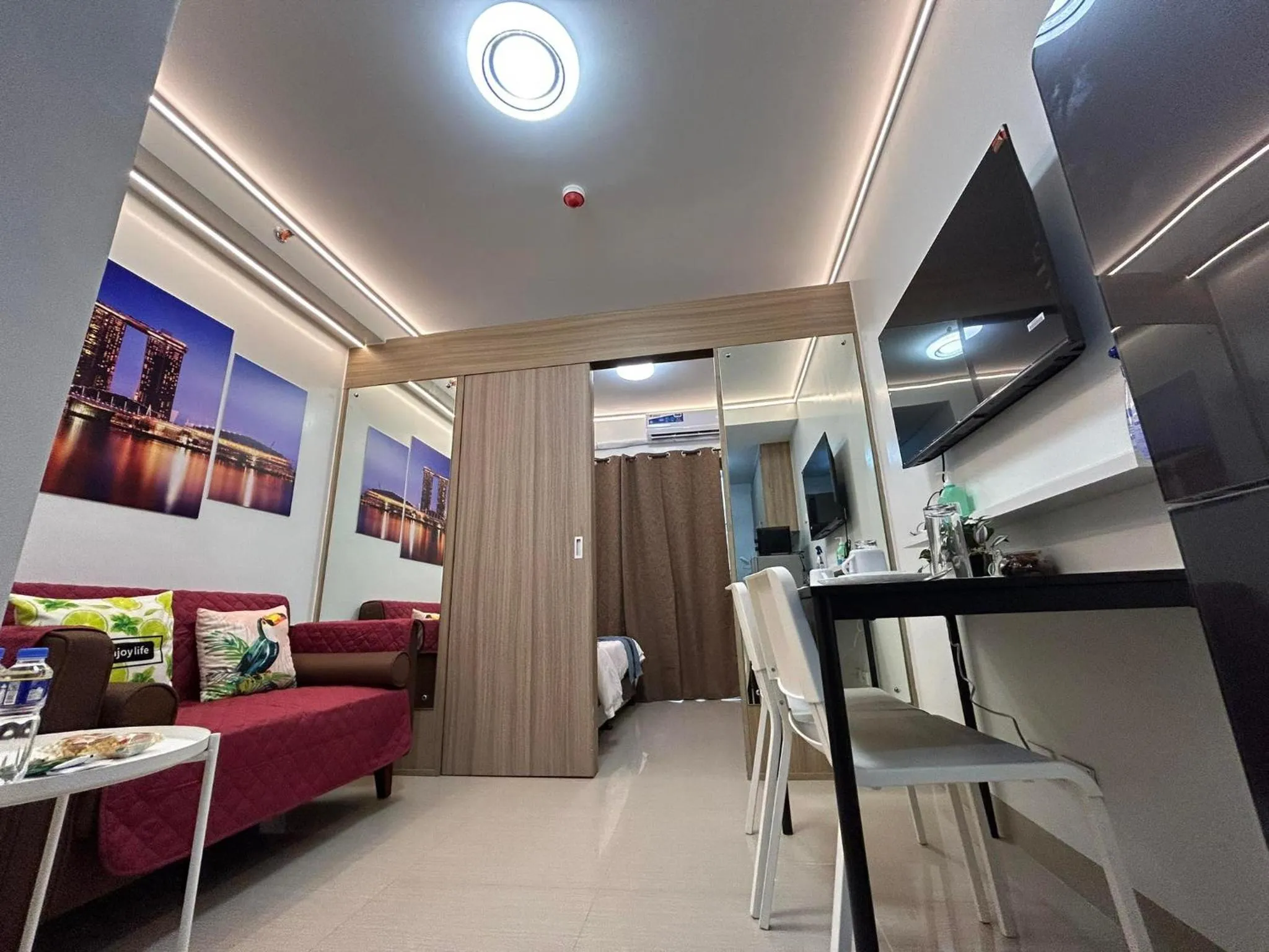 Living room, Bed in Shore Residences MOA Dynastel Staycation