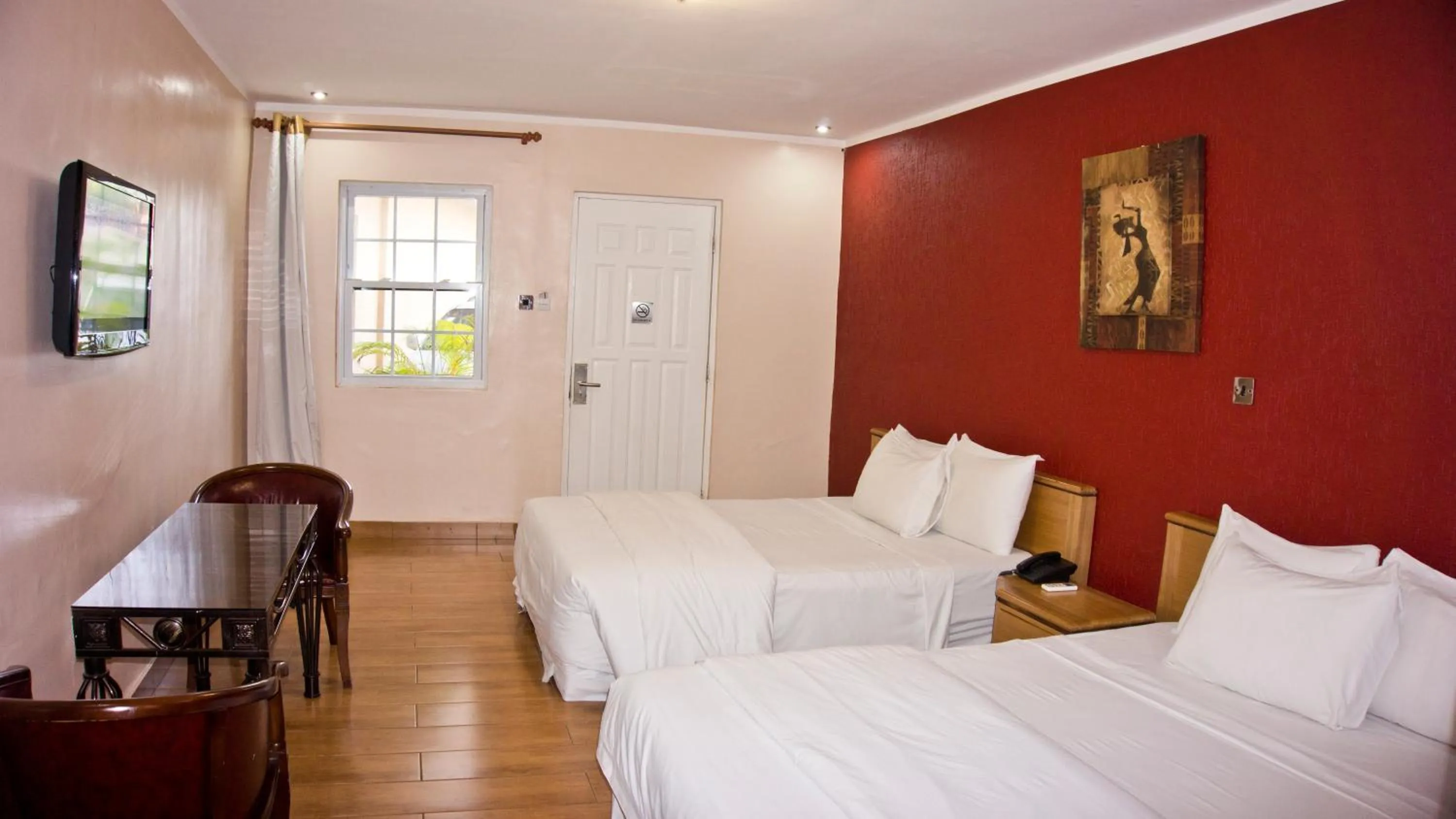 Bed in Tropical Enclave Hotel