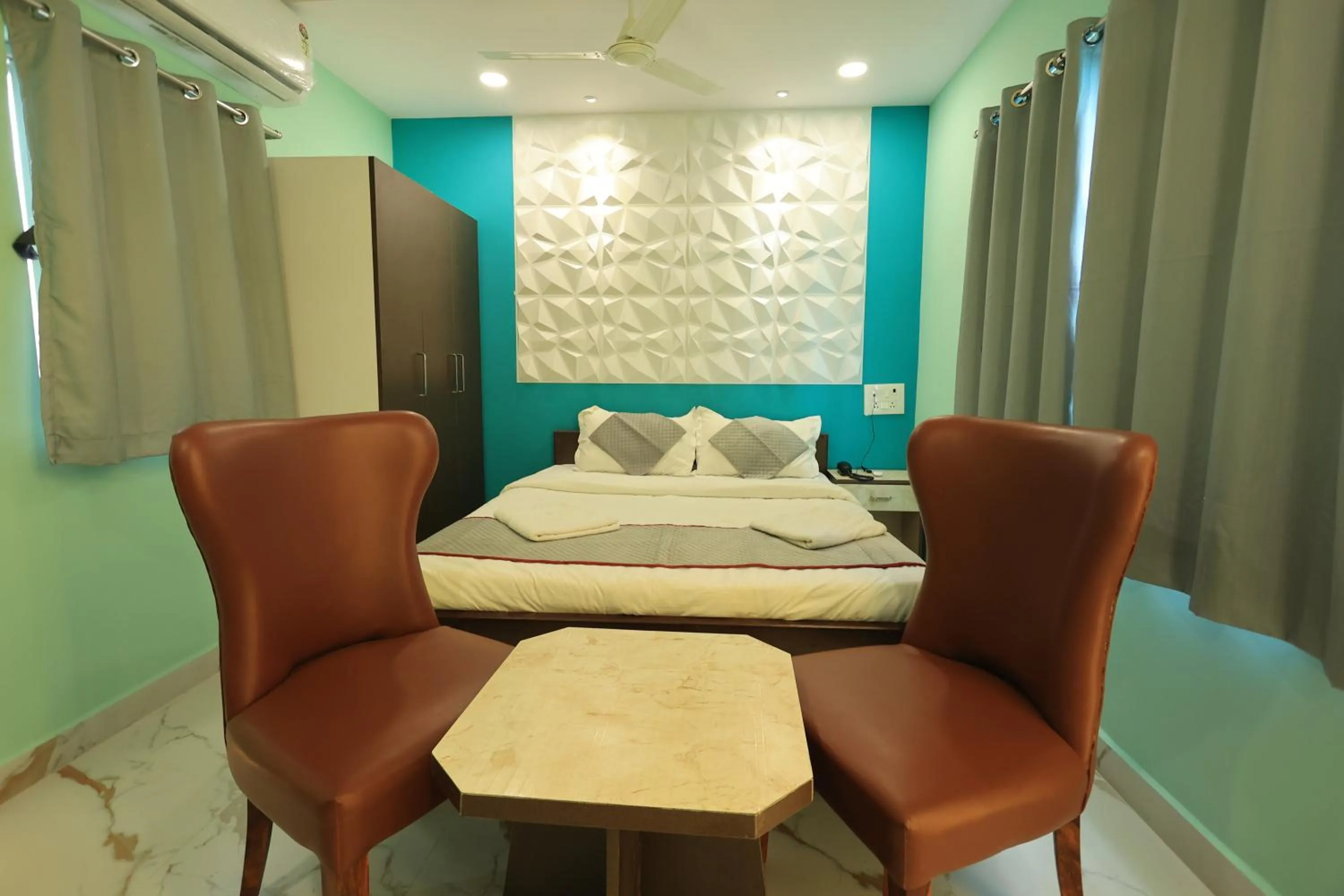 Seating area, Bed in Kailasaa Residency
